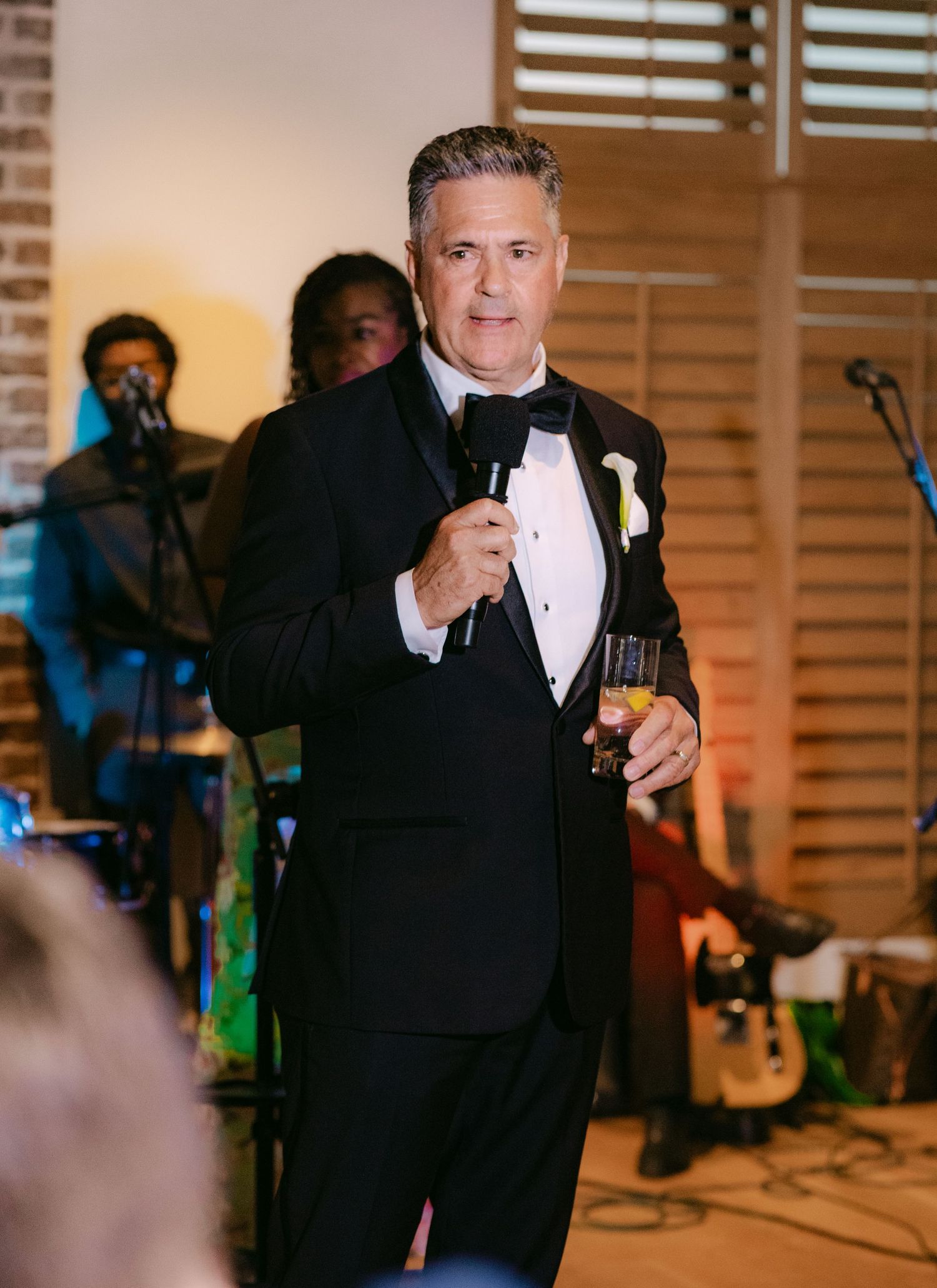 Someone in formal attire performs during wedding reception entertainment.