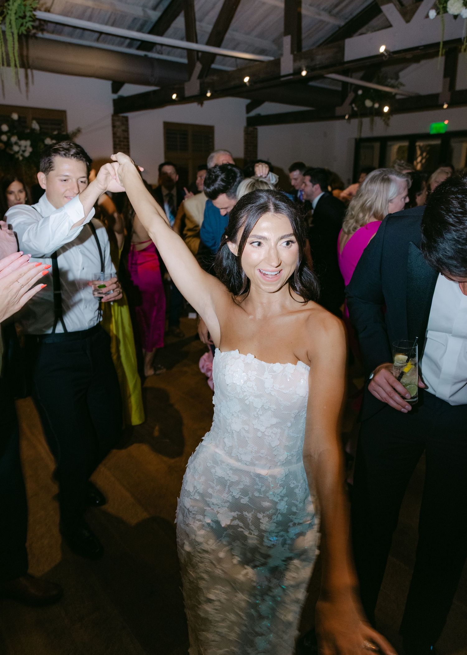 Wedding reception dance floor filled with guests enjoying the celebration.