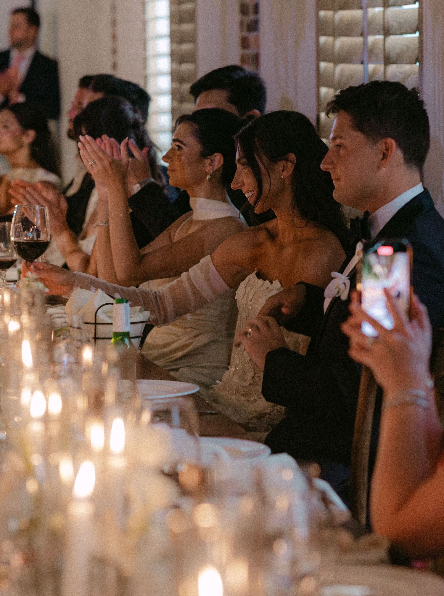 Wedding guests react emotionally during reception speeches and toasts.