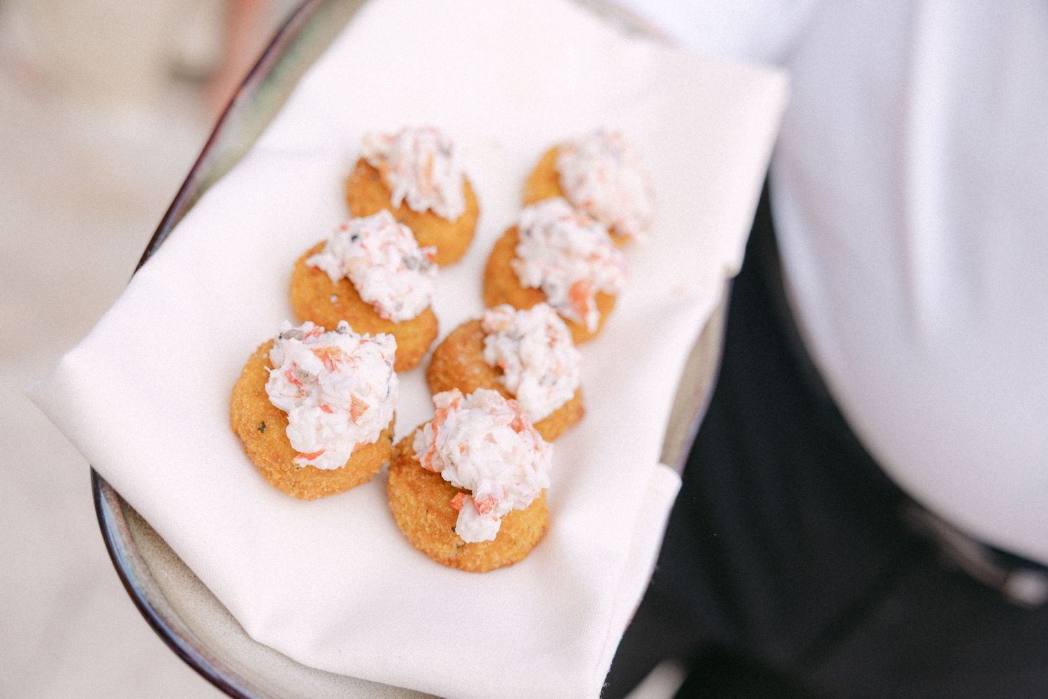 Close-up shots of cream-colored pastries topped with white frosting on a light surface.