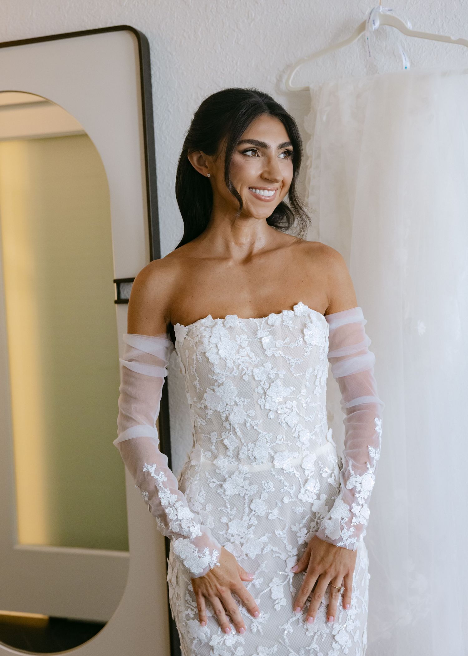 Close-up shots showcasing intricate floral applique details on an off-shoulder wedding gown.