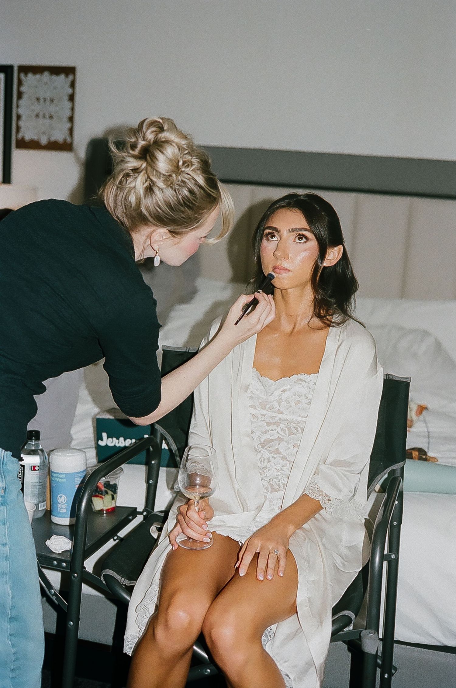 Behind the scenes of wedding day preparation with makeup artist at work.