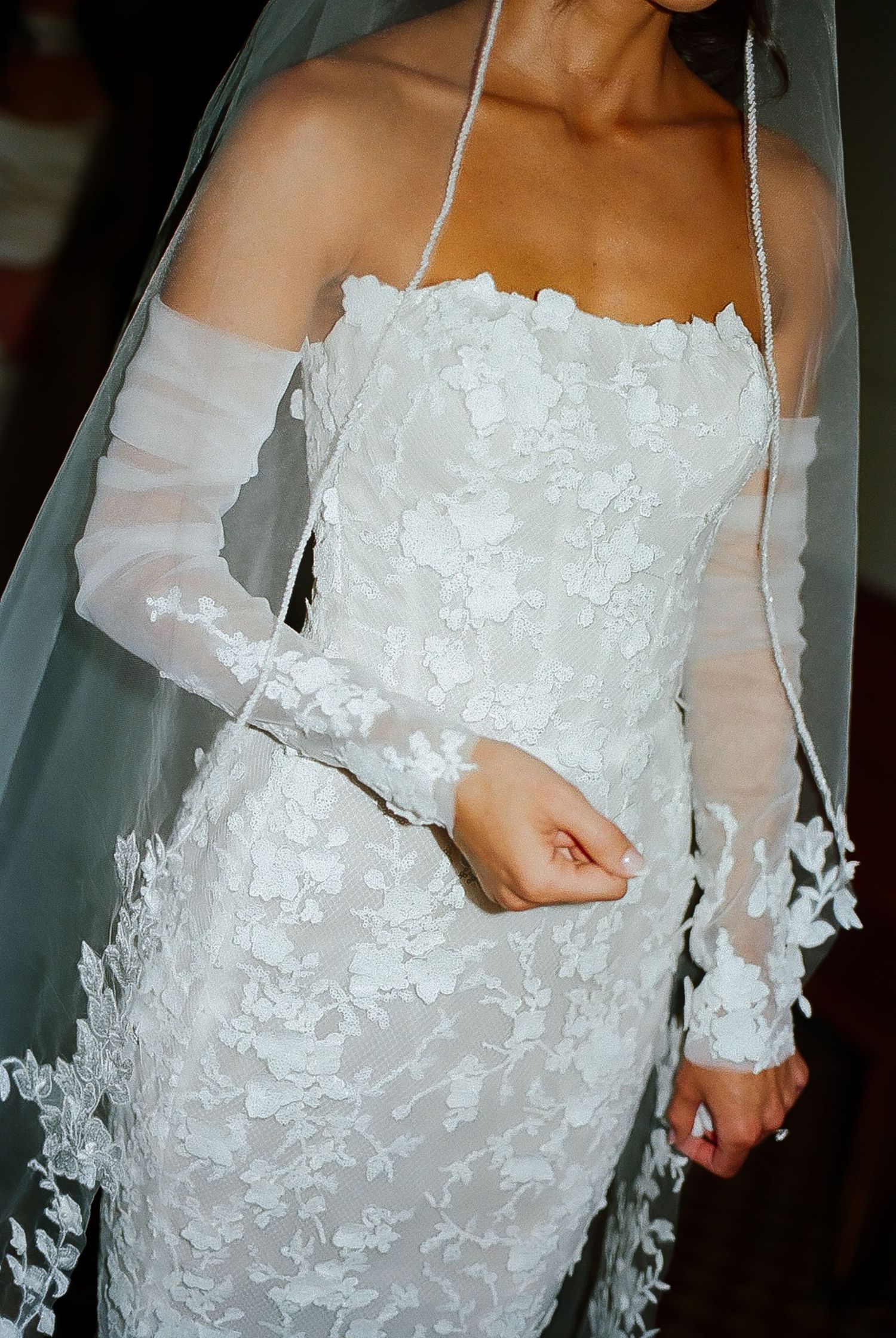 Wedding dress detail shots featuring delicate lace appliques and sheer sleeves.