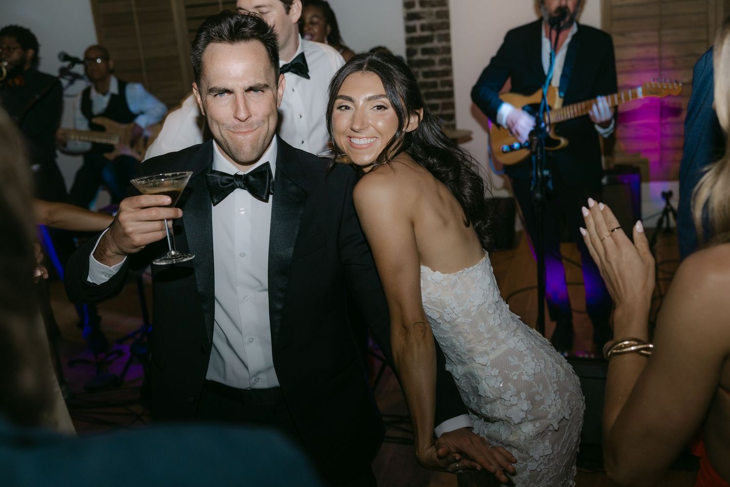 Elegant couple in formal attire celebrating at a wedding reception.