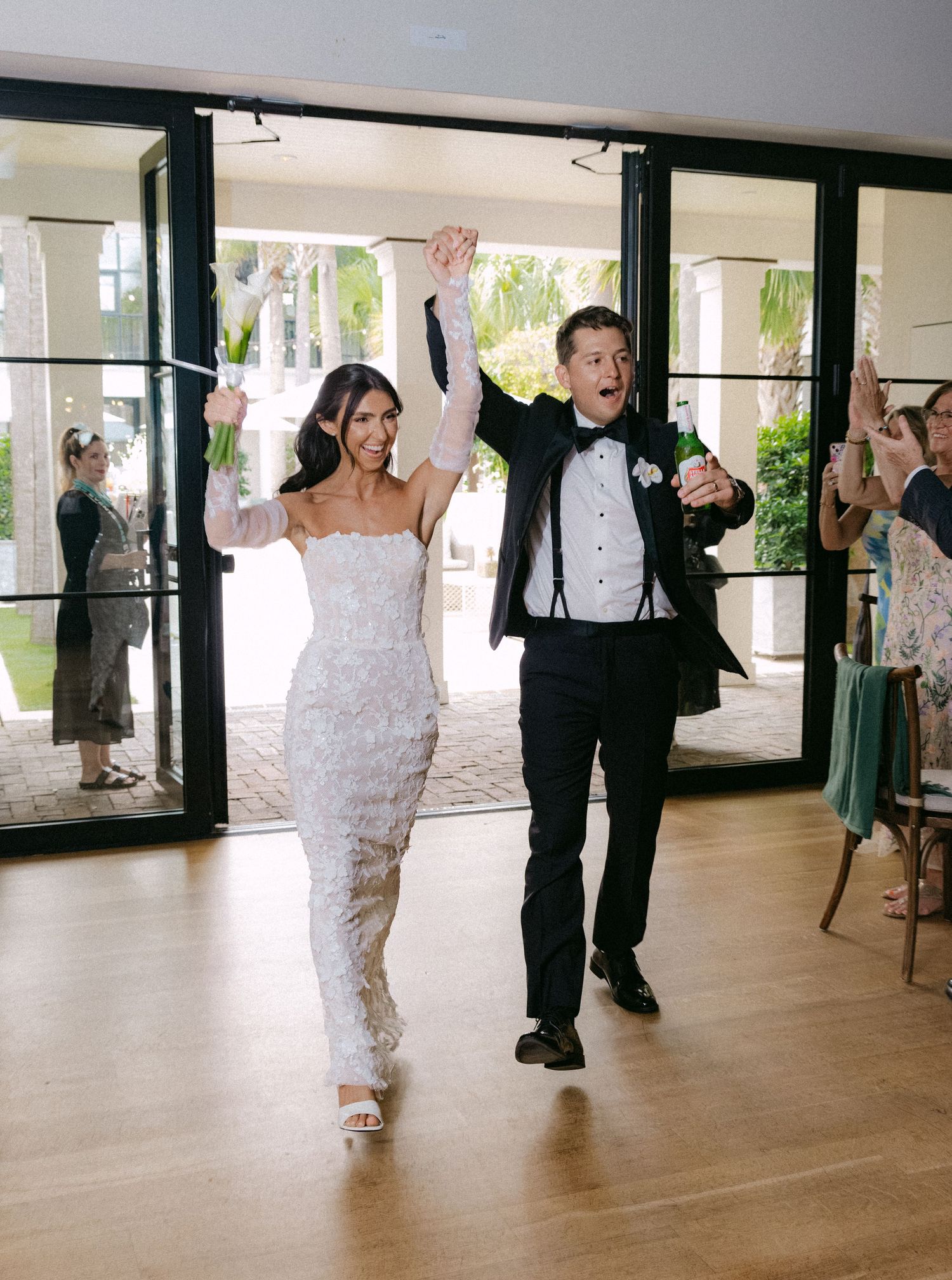 Wedding couple dances together in an elegant ballroom during their first dance celebration.