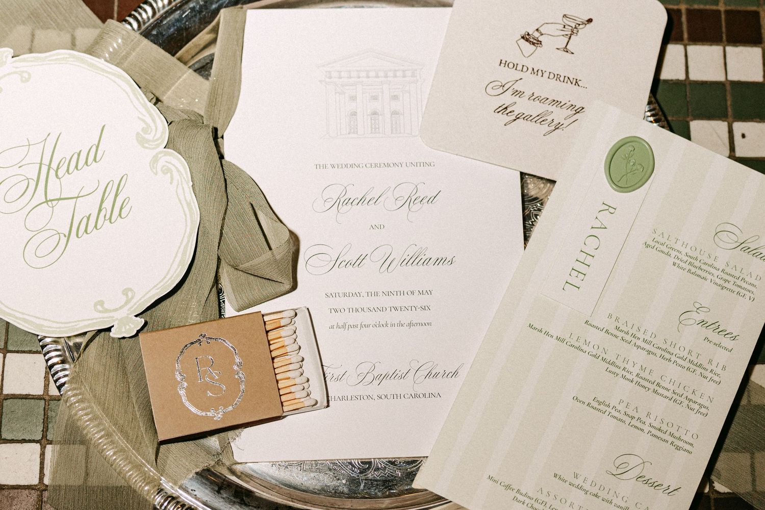 Elegant wedding stationery suite with invitation, menu, and matchbook on silver tray.