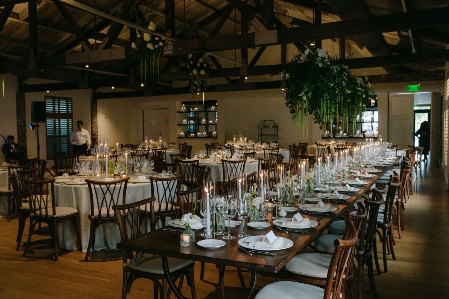 Atmospheric dining room with wooden beams and tables arranged for a special event.