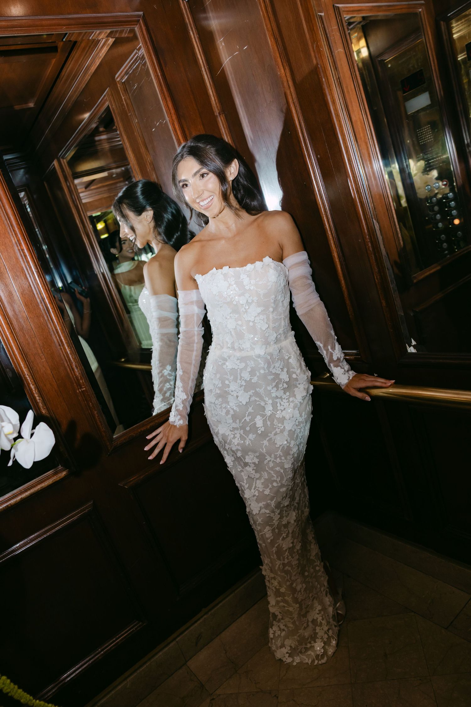 Artistic shots of a bride in a beaded off-shoulder gown against dark wood paneled walls.