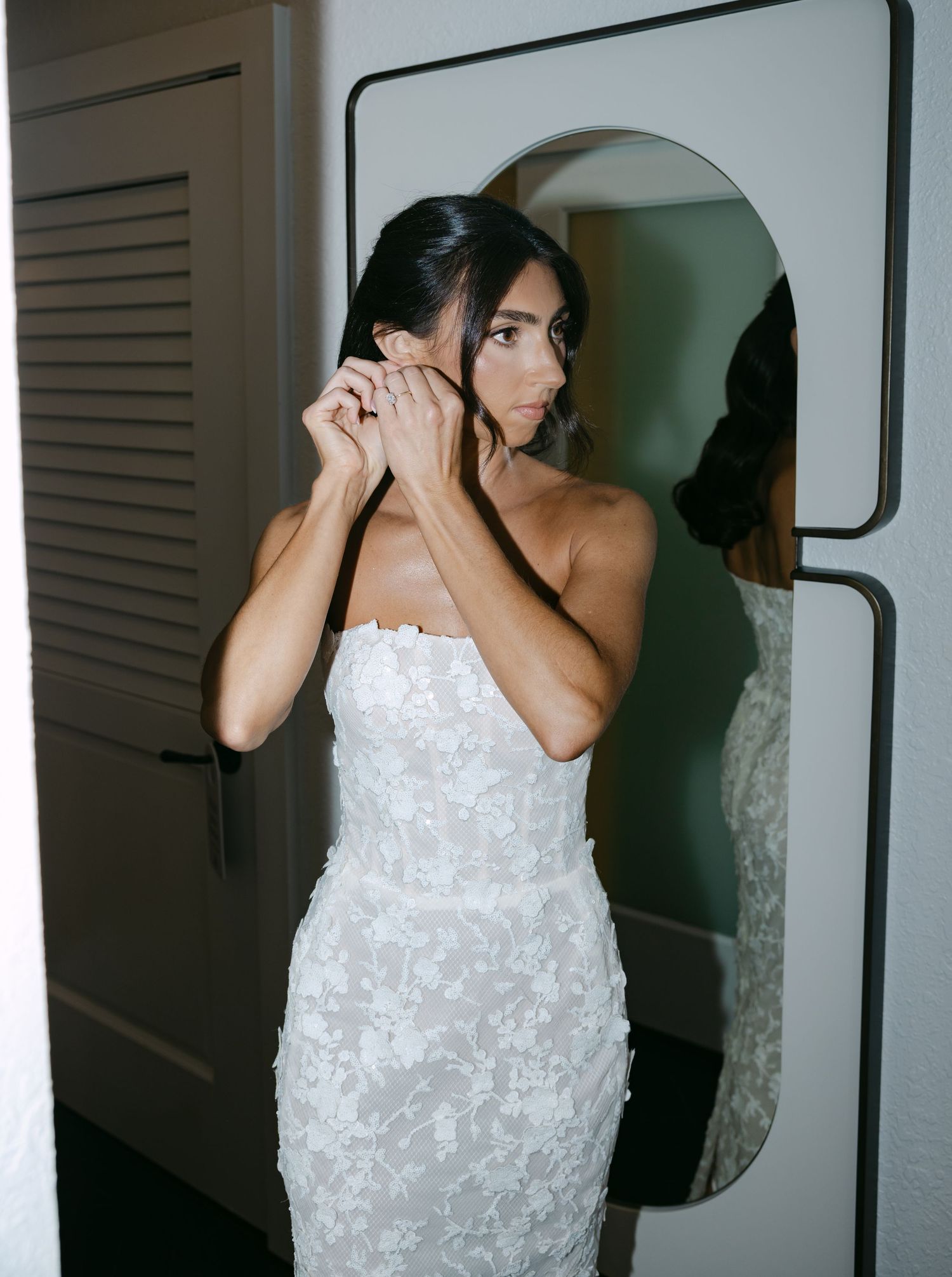 A sequence of photos showing a bride in a white floral textured dress getting ready.