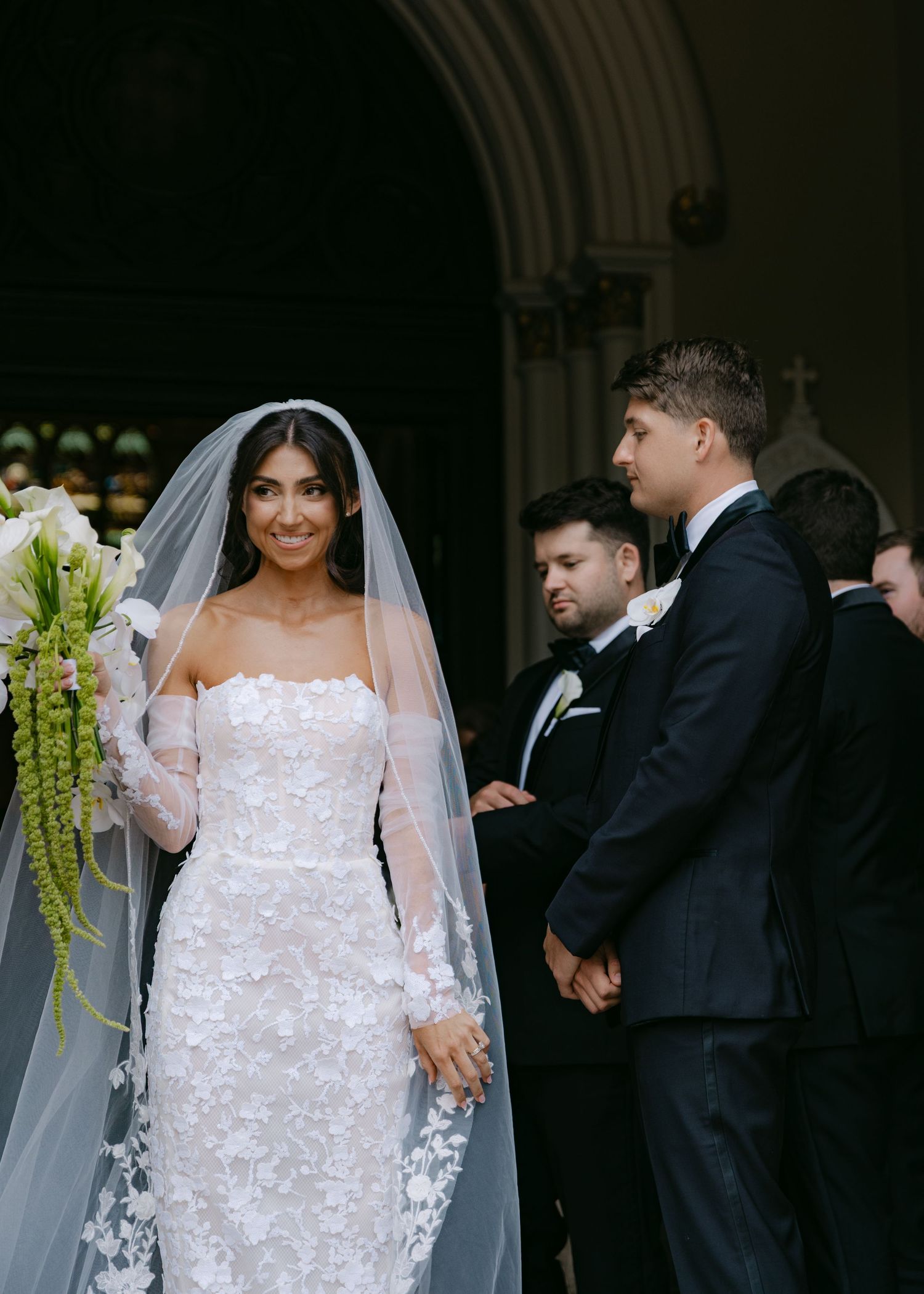Wedding sequence showing happy moments between couple and guests in church hallway.