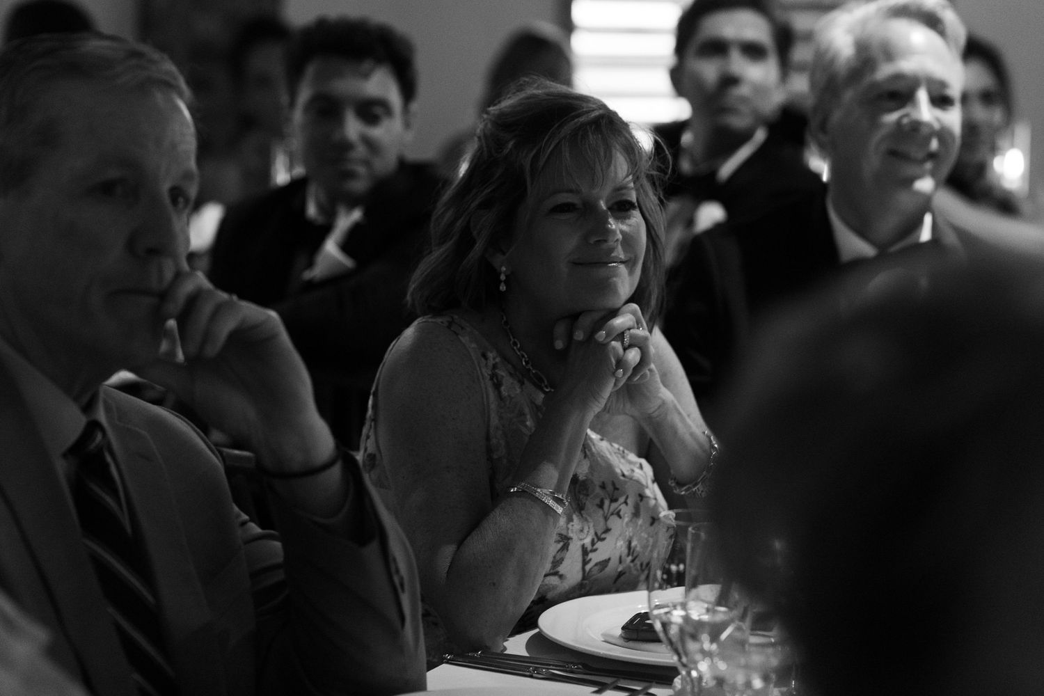 Black and white candid shots of wedding guests during reception.