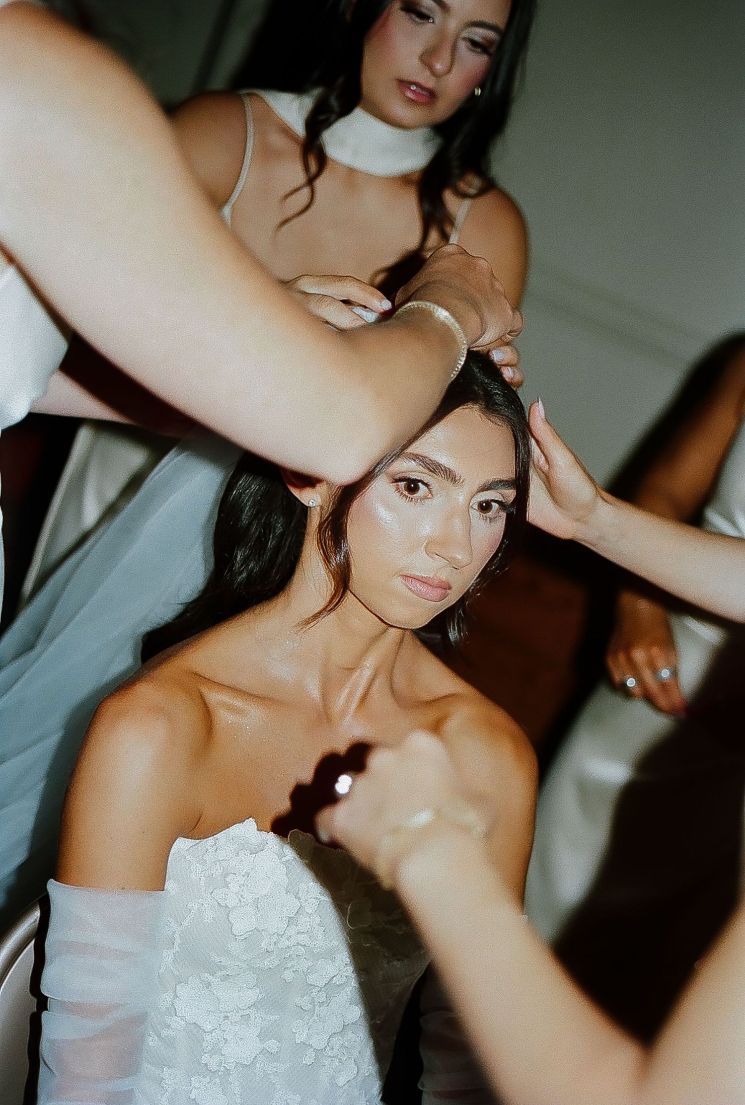 Close-up shots of a strapless white wedding dress with intricate lace details.