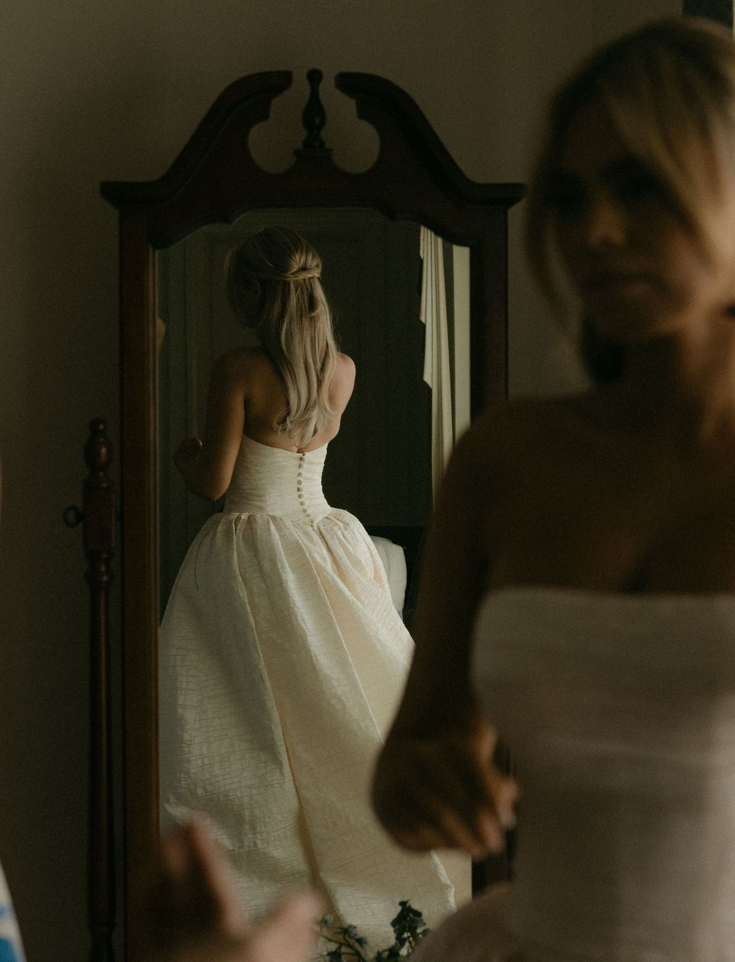 Vintage-style wedding dress details showing intricate white lace and fabric in a classic silhouette.