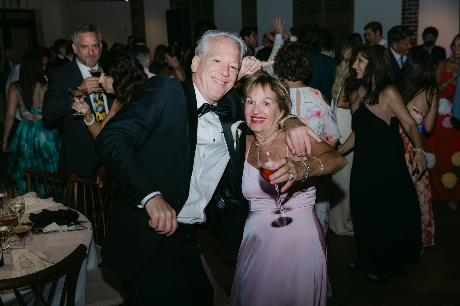 Festive couple dancing and enjoying themselves at an evening celebration.