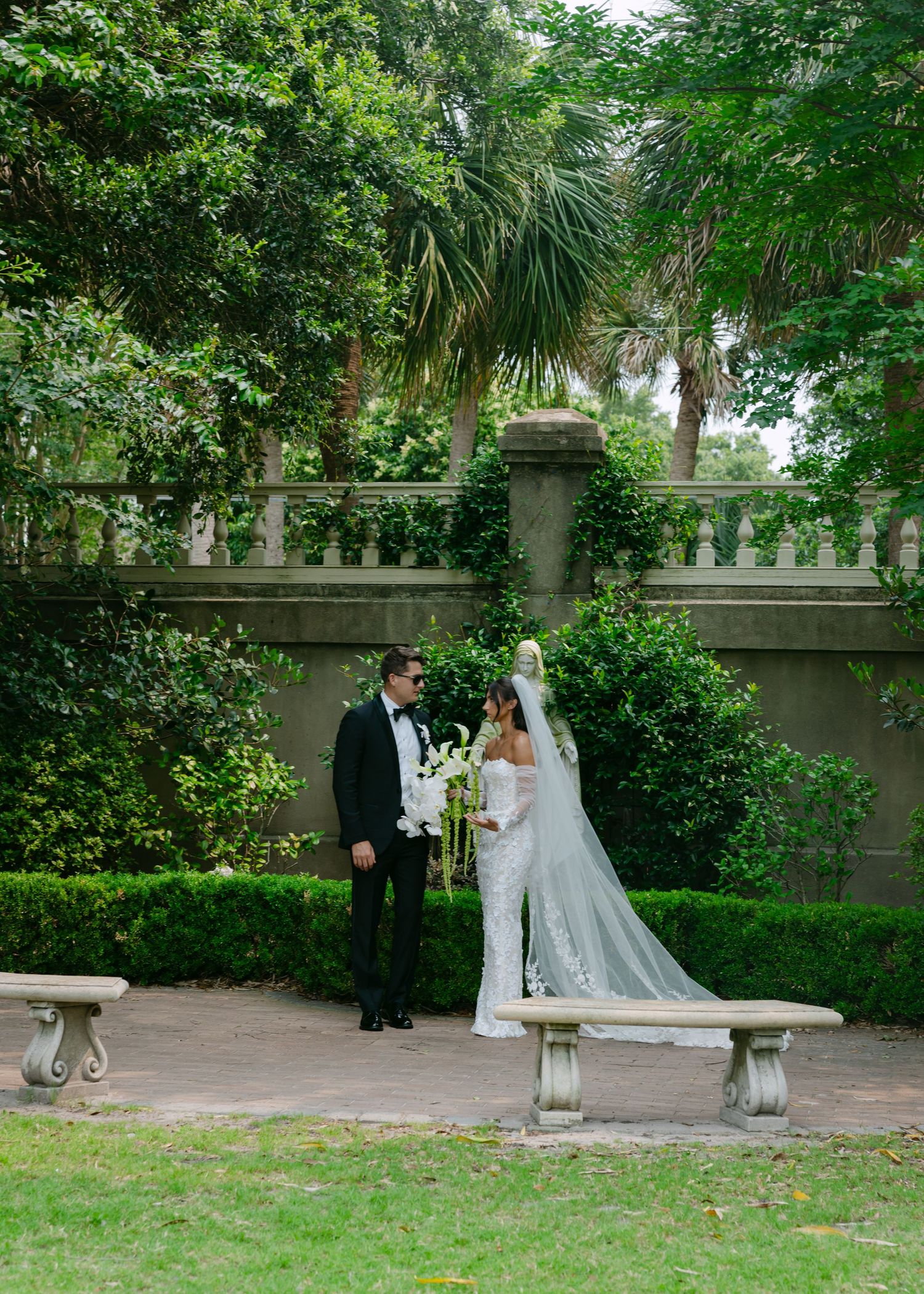 Romantic wedding photography session in a serene garden setting with traditional architecture.