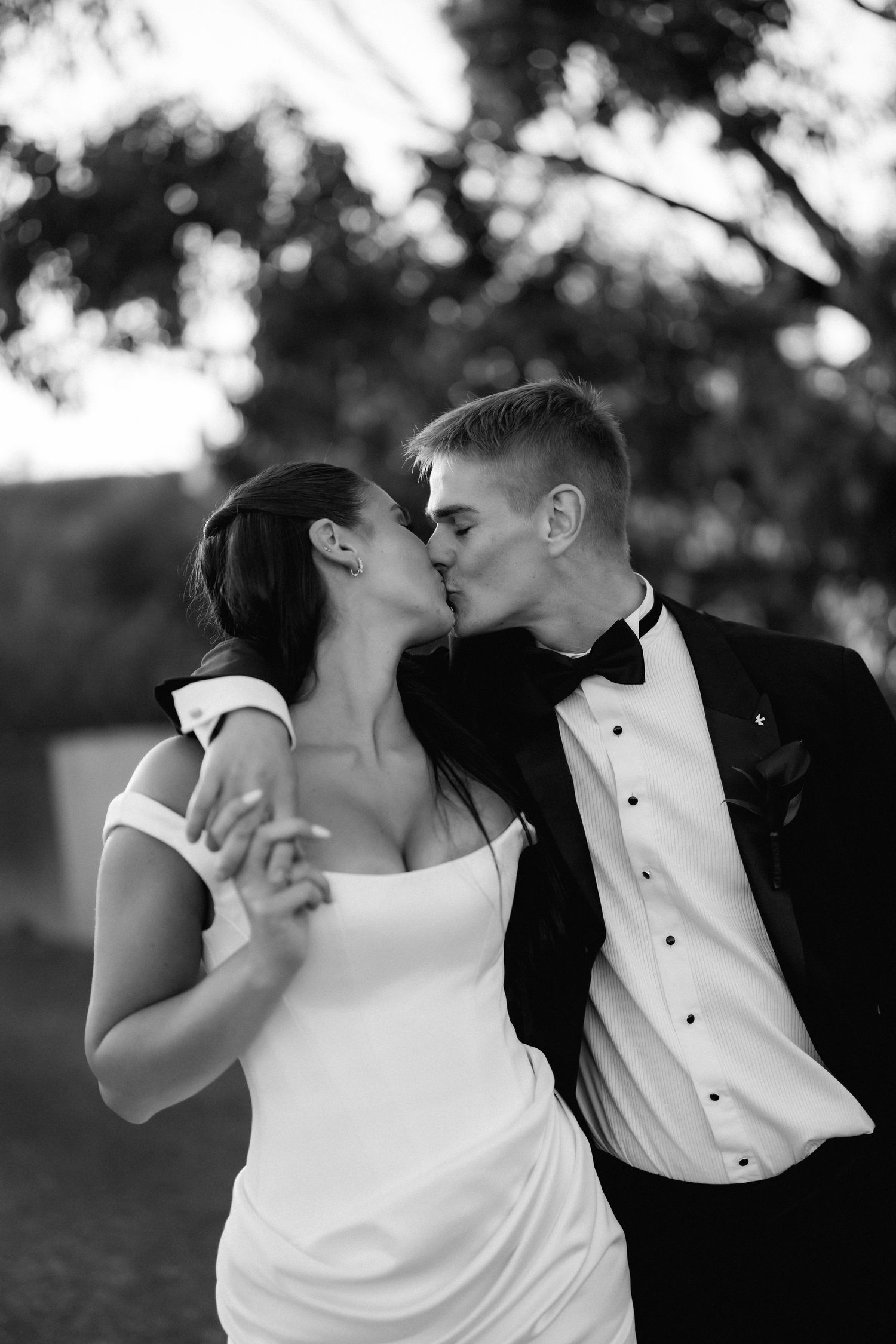 Black and white romantic wedding couple portraits in an outdoor setting.