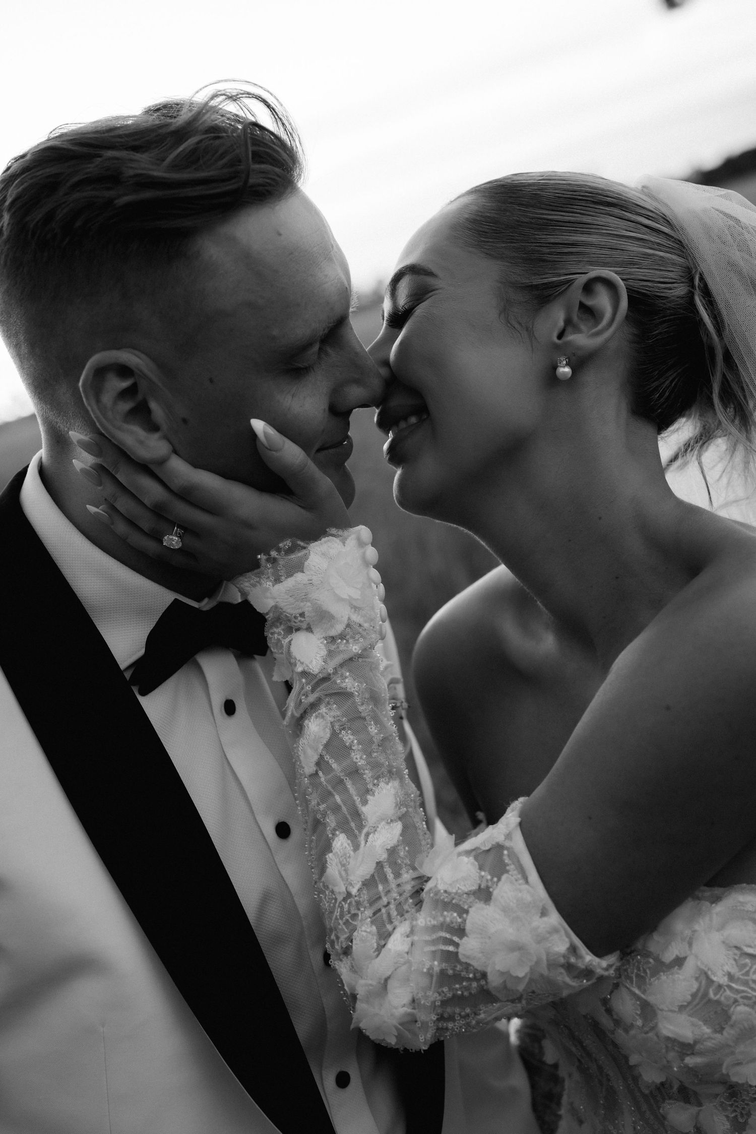 A romantic series of black and white wedding photos showing intimate moments between newlyweds.
