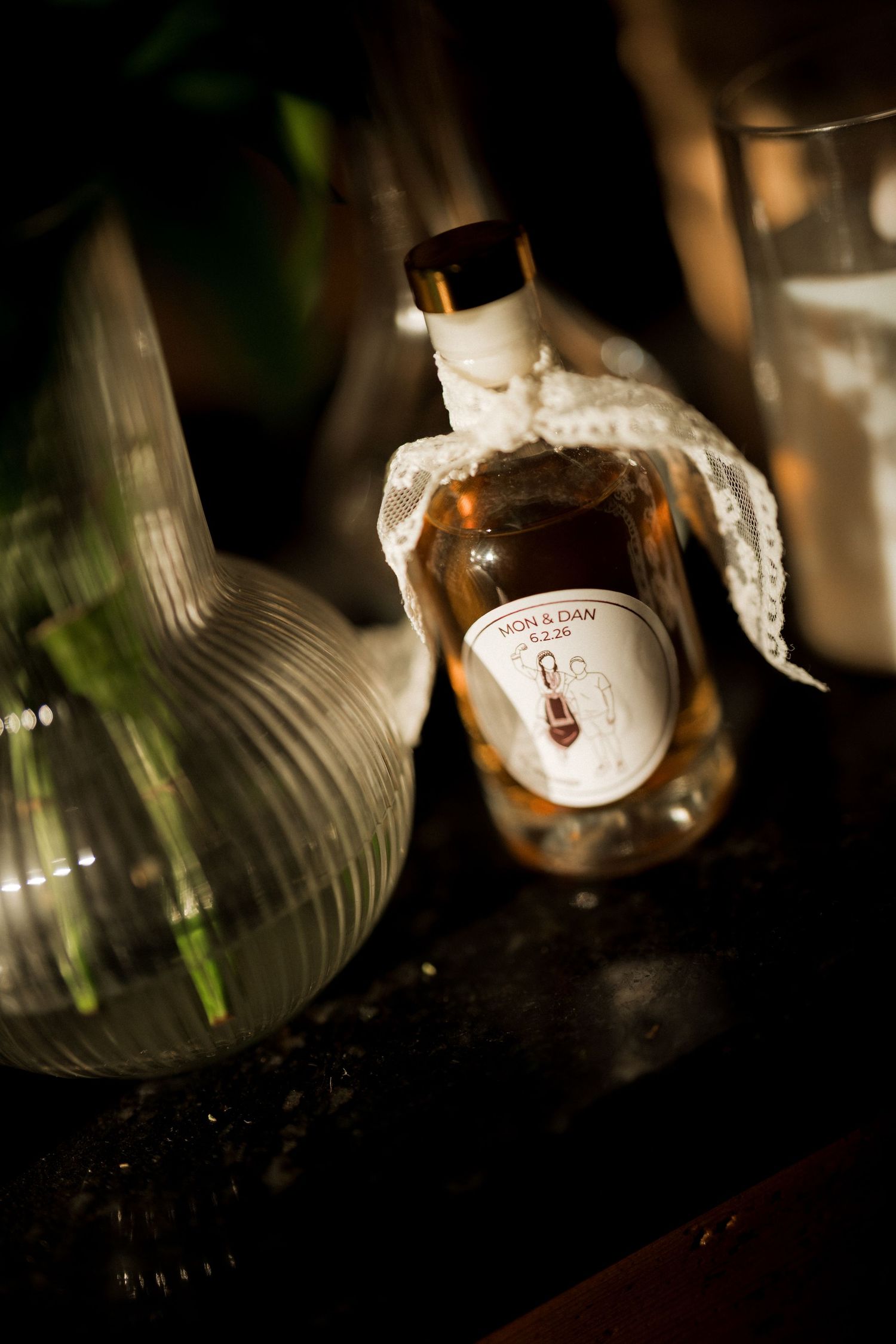 Artistic close-up shots of wine bottles in dark lighting.