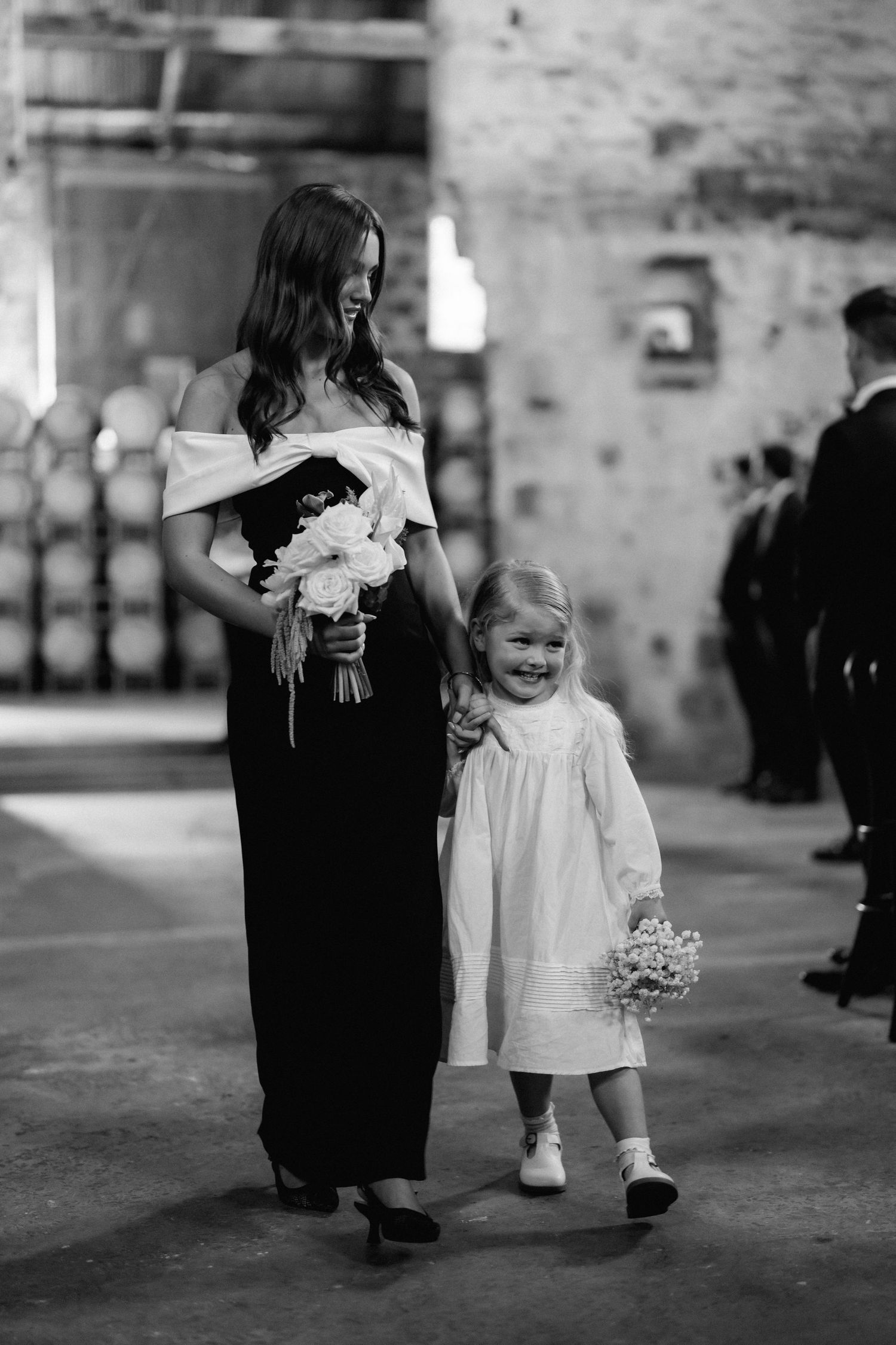 Black and white photos of children walking in formal attire during a wedding procession.