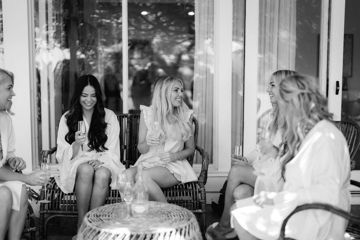 Wedding party gathered indoors for pre-ceremony preparations in casual attire.