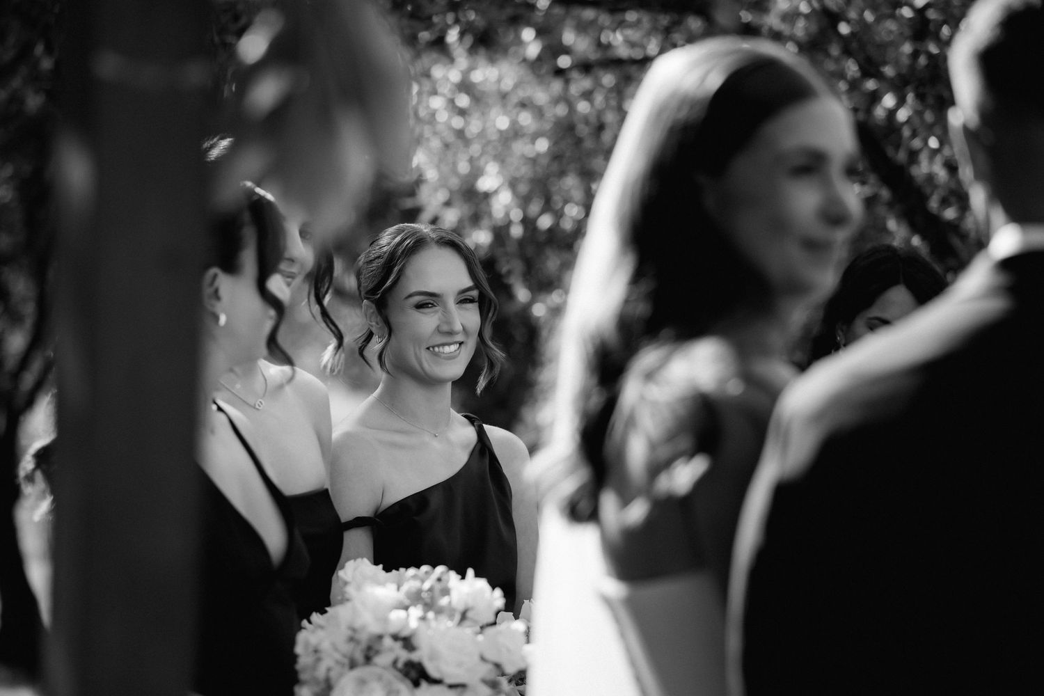 Black and white wedding photos showing happy couples dancing and celebrating at an elegant reception.