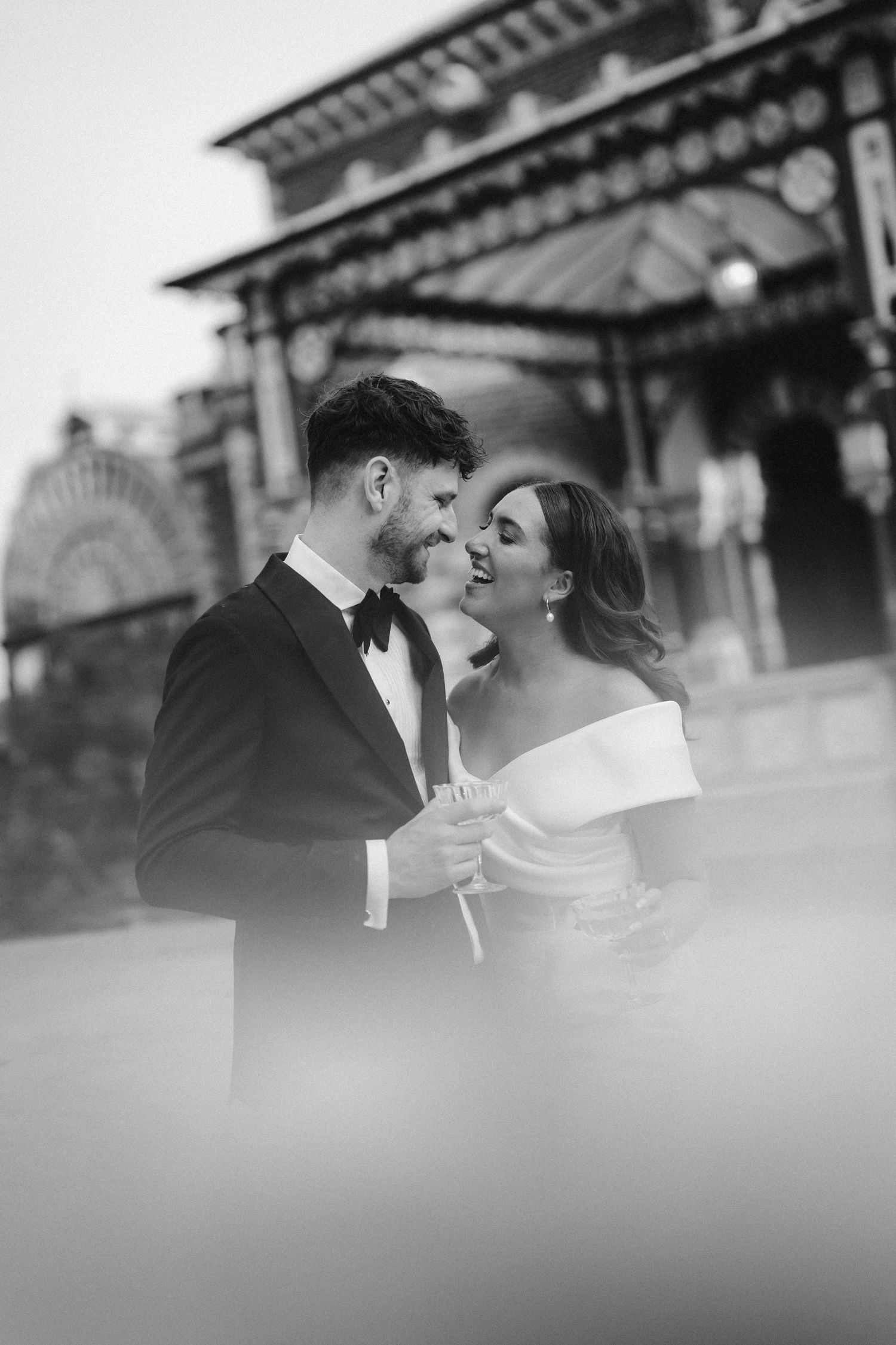 A romantic black and white portrait of newlyweds sharing an intimate moment together.