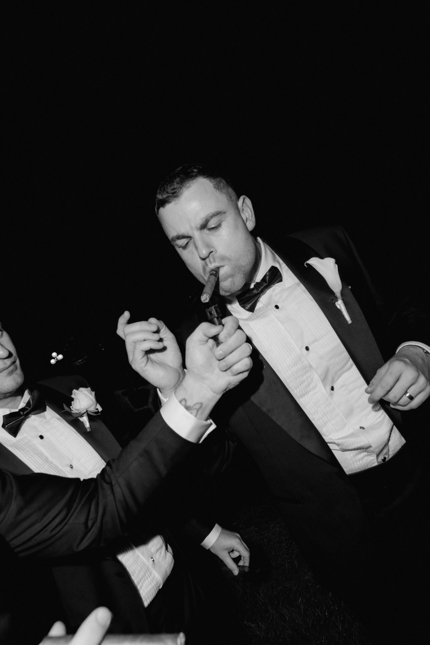 Black and white artistic portrait series of groomsmen in formal tuxedos.