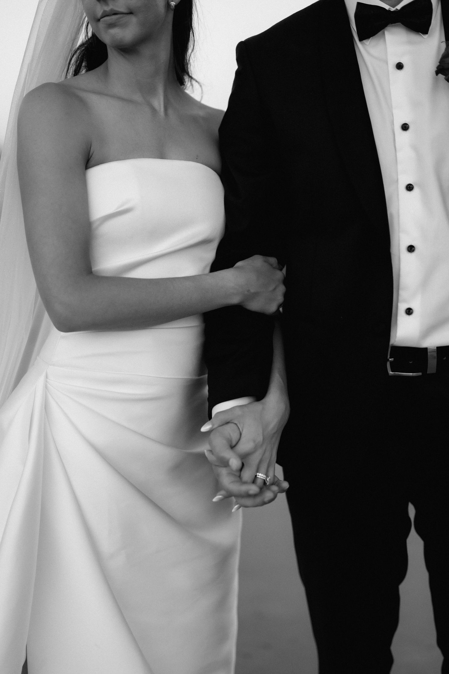 Wedding couple in elegant black and white attire shown in a series of cropped formal poses.