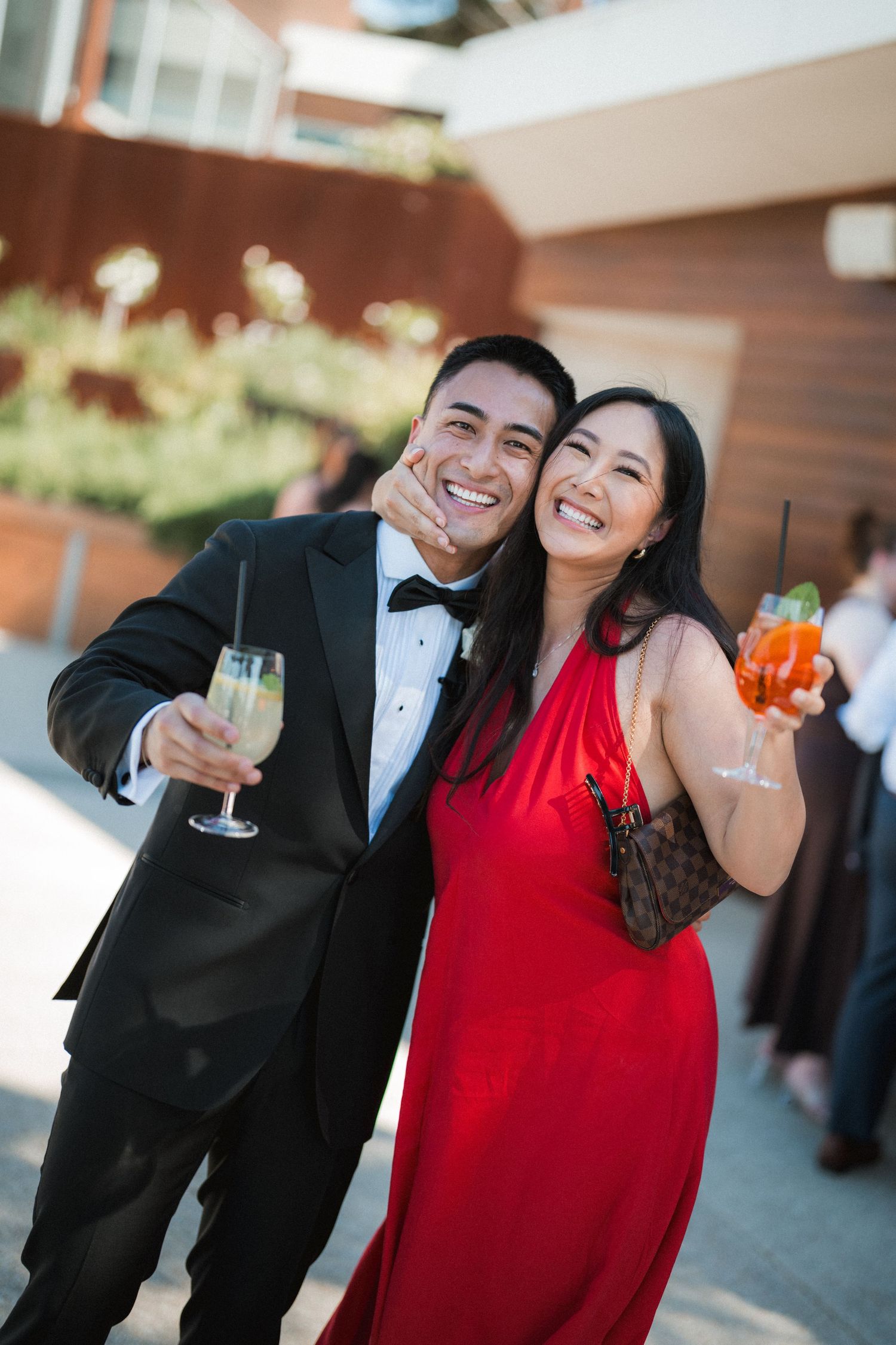 Celebratory moments with drinks and laughter at a formal event.