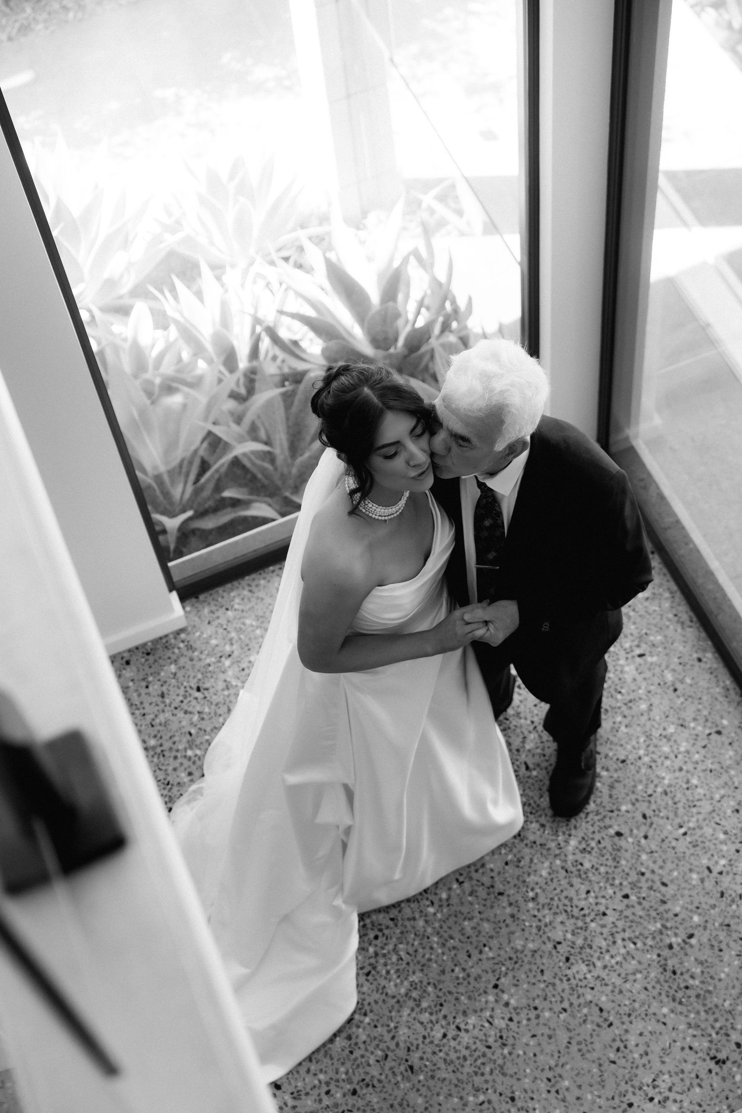 A black and white artistic photo series showing a person in a white wedding dress resting on the floor.