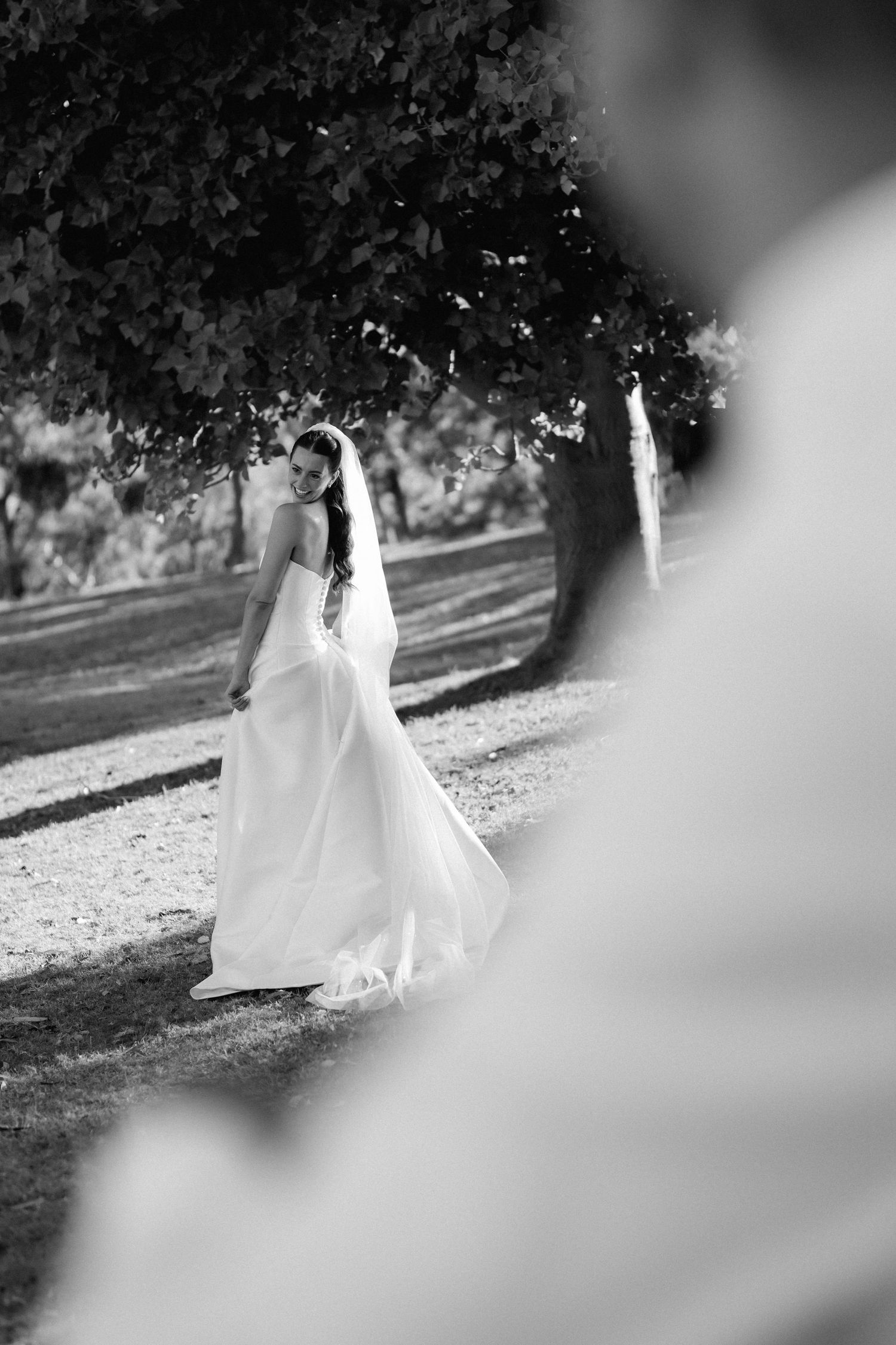 Artistic black and white sequence showing a bride and groom walking through an outdoor setting.