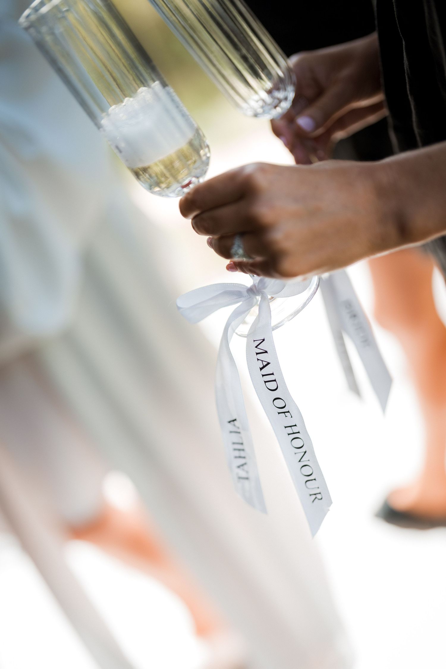 Close-up shots of champagne glasses with name tags being arranged in sequence.