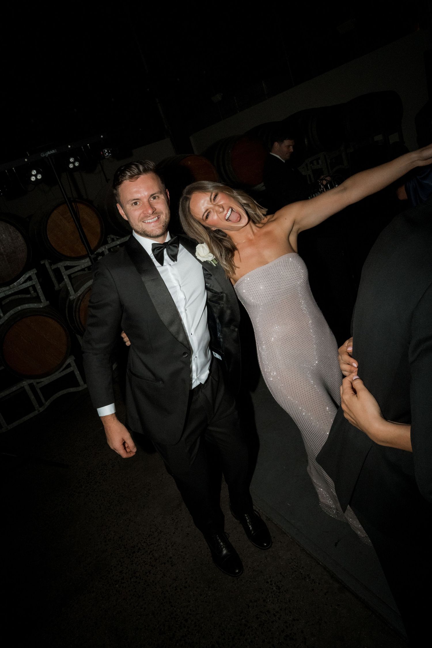 People dancing and celebrating at a formal evening party in black tie attire.