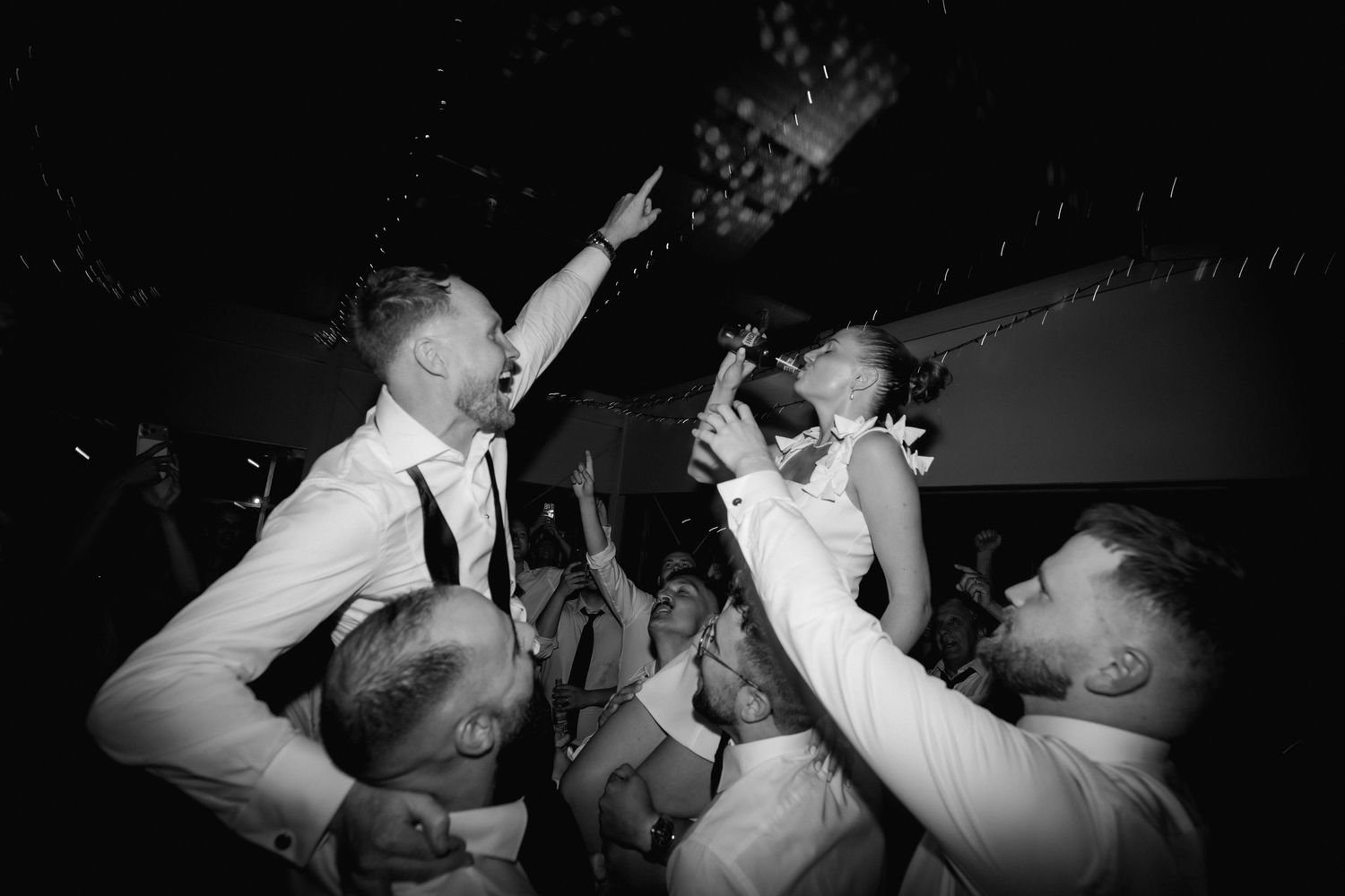 Black and white photo of wedding reception dancing and celebration.