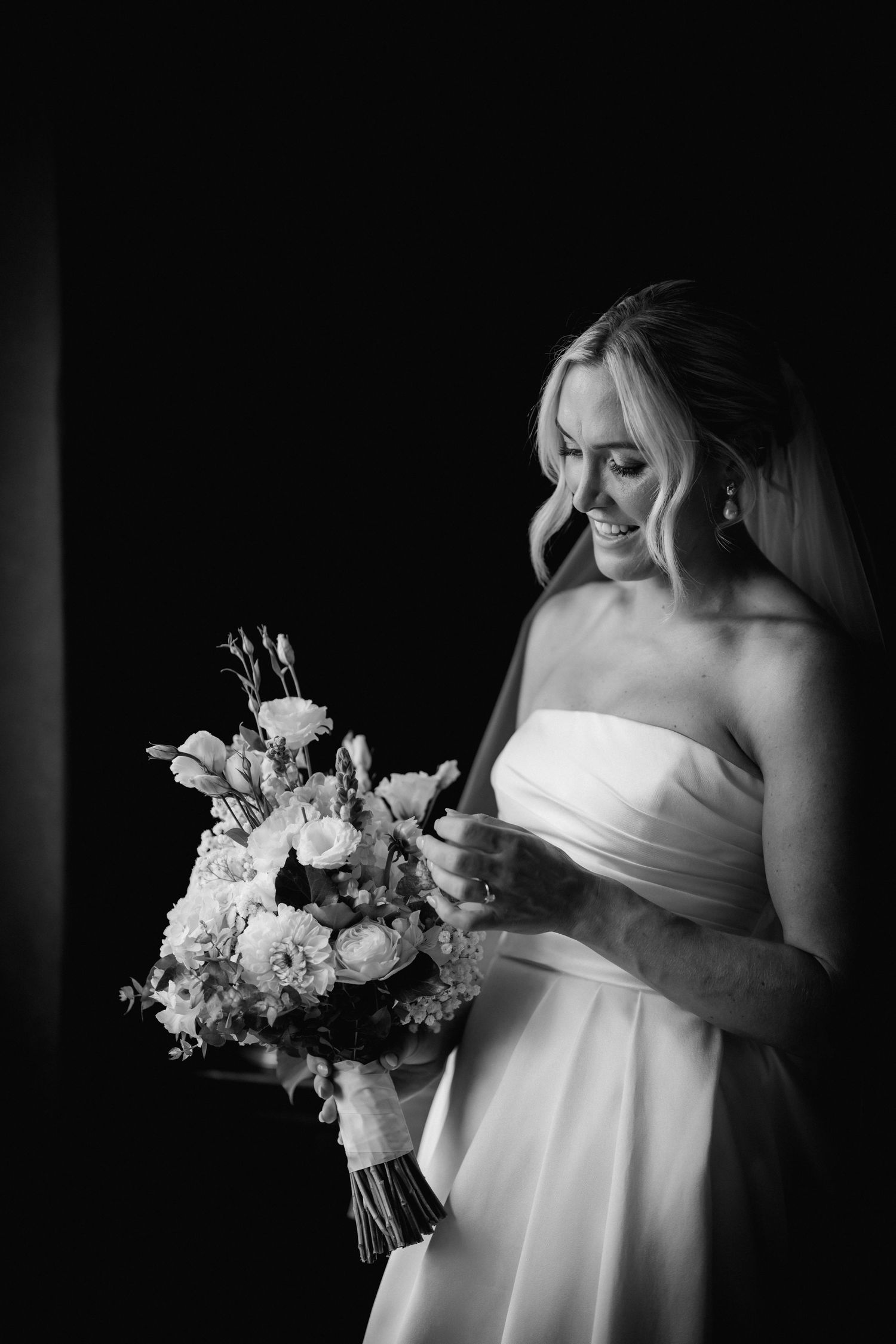 Bride holding a beautiful white and cream floral bouquet.