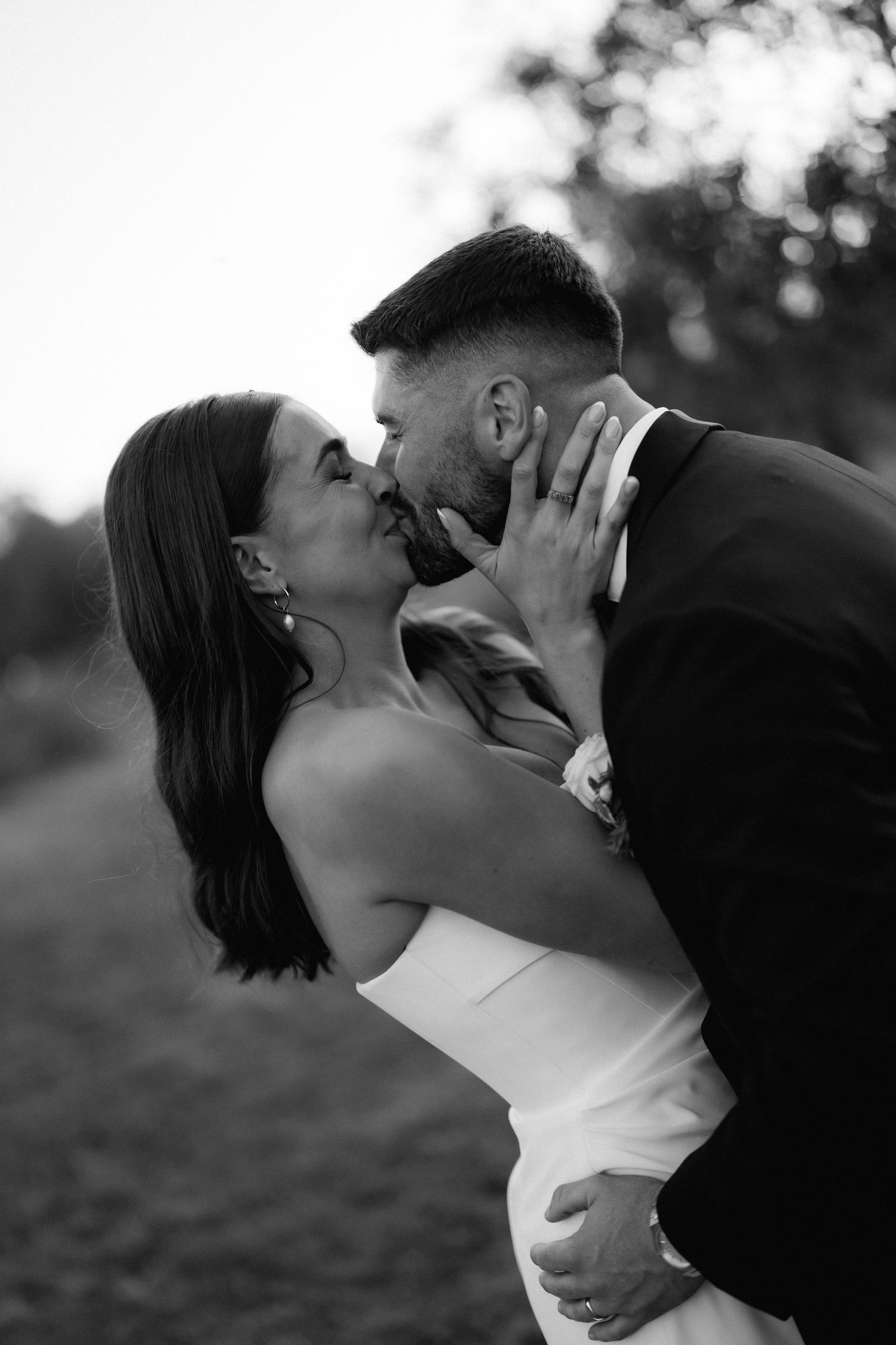 Romantic black and white portrait of newlyweds sharing an intimate moment.