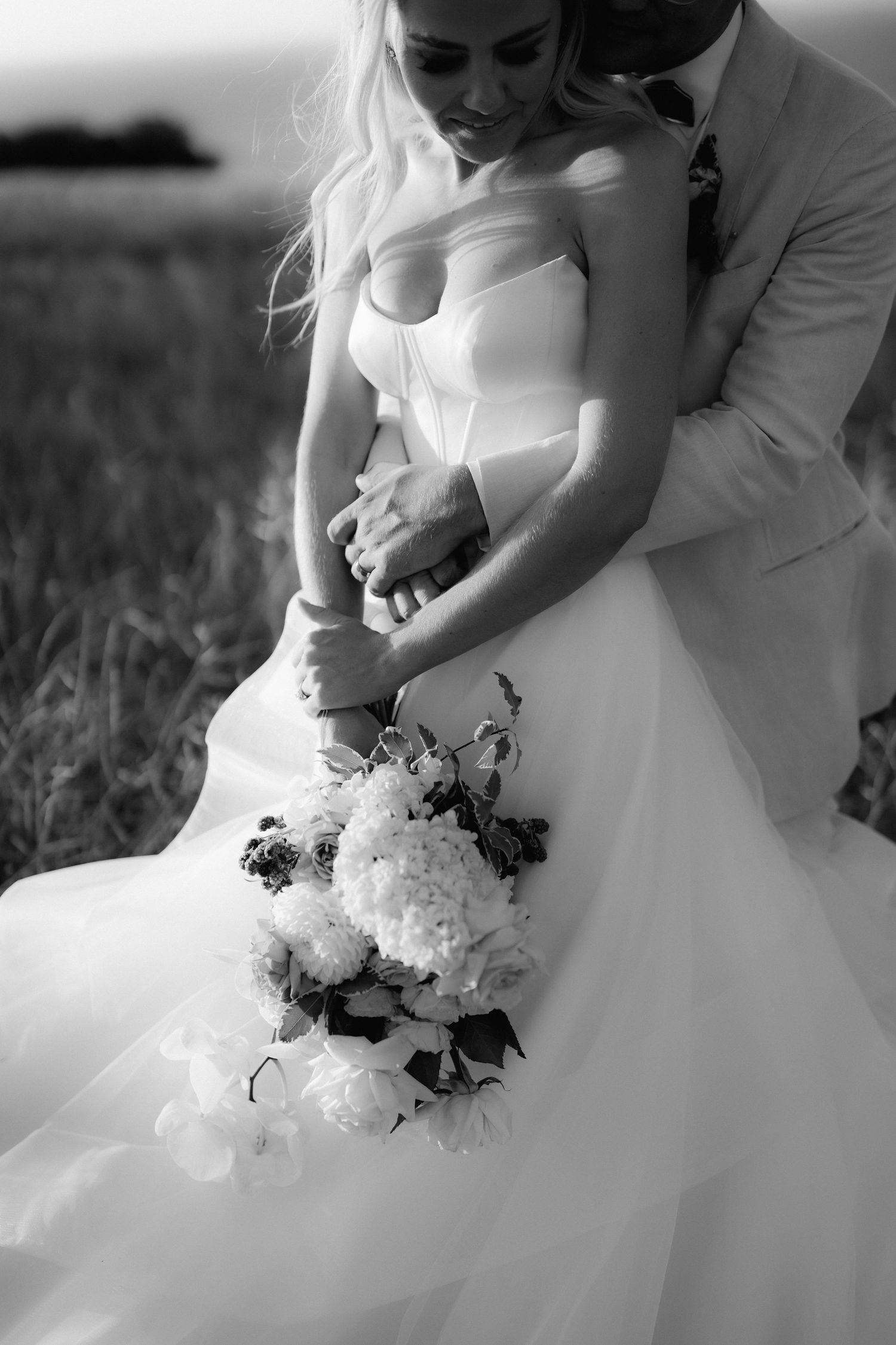 Black and white close-up of wedding bouquet with white flowers.
