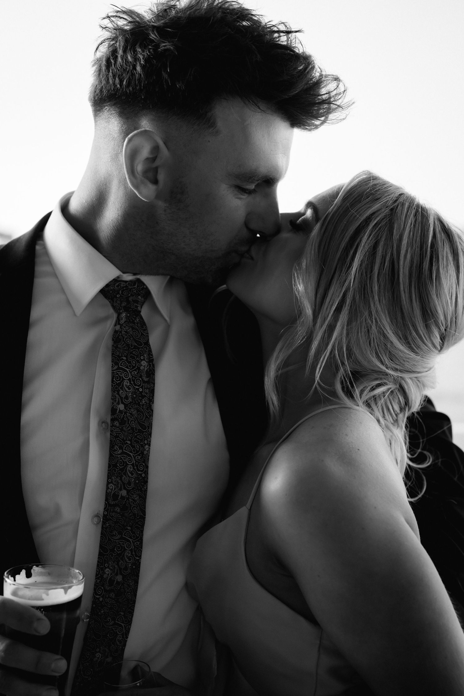 High contrast black and white romantic portraits of a couple sharing tender moments.