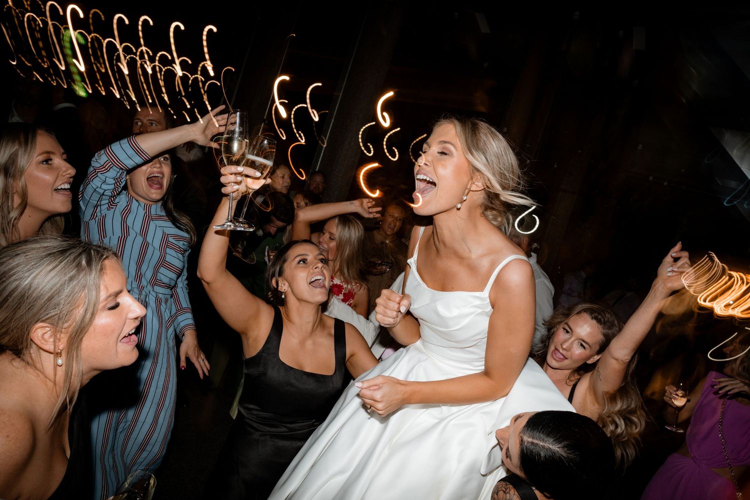 Wedding reception dance party with candy canes decorations hanging overhead.