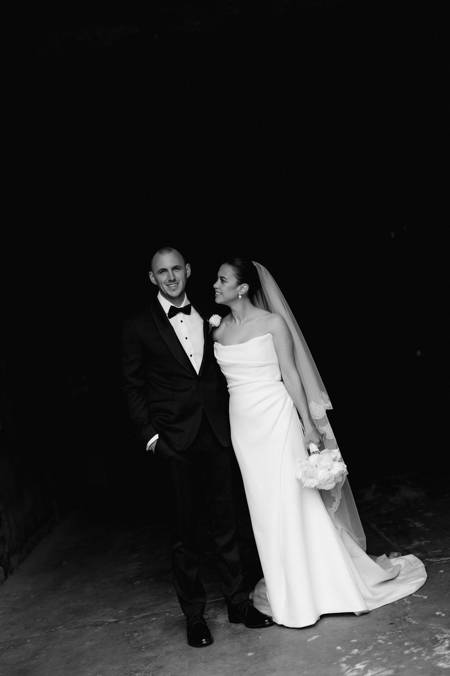 Artistic black and white wedding portraits on a dark background.