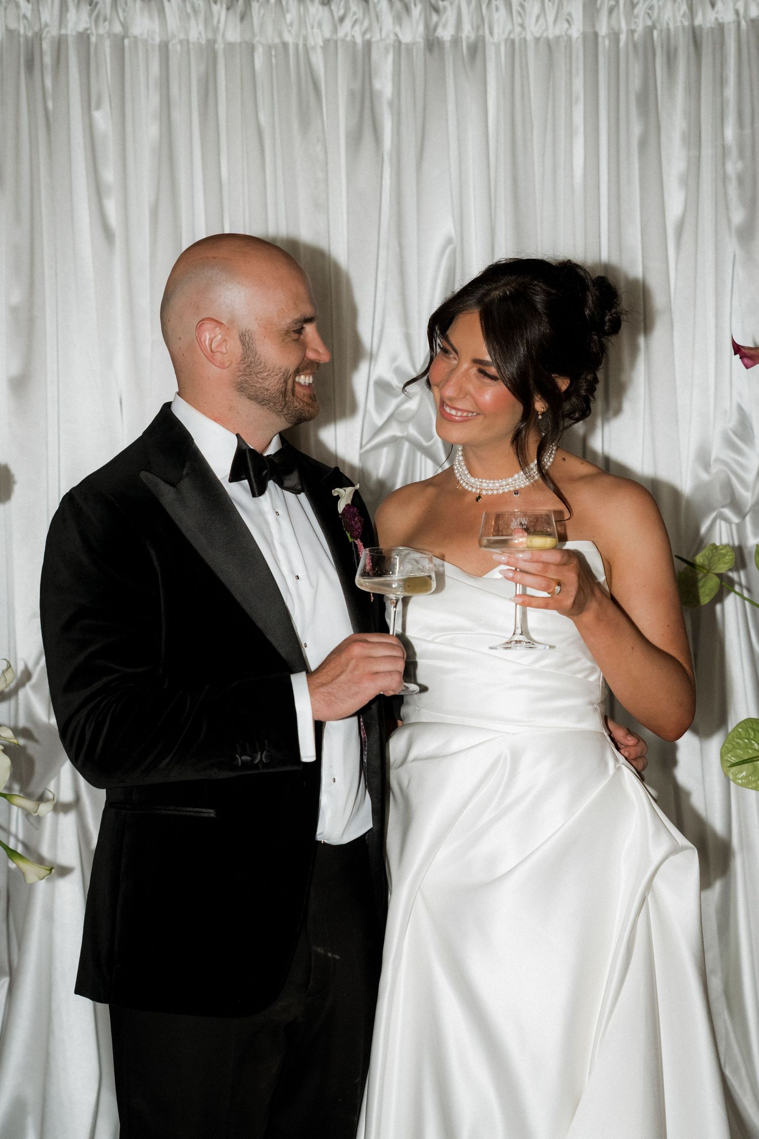 Newlyweds share champagne and intimate moments during their wedding reception.