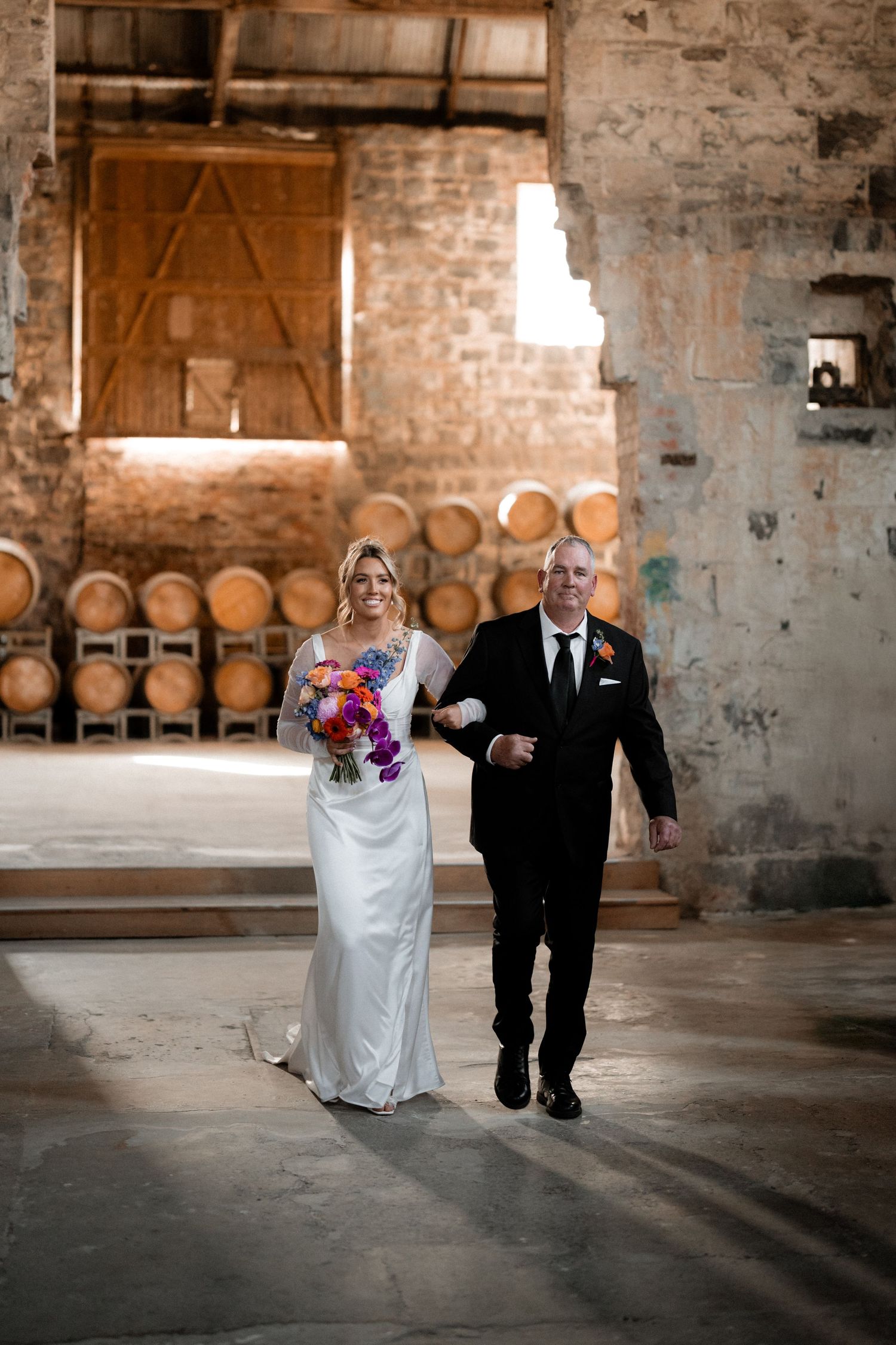 Wedding couple poses progressively across rustic brick venue in creative portrait sequence.