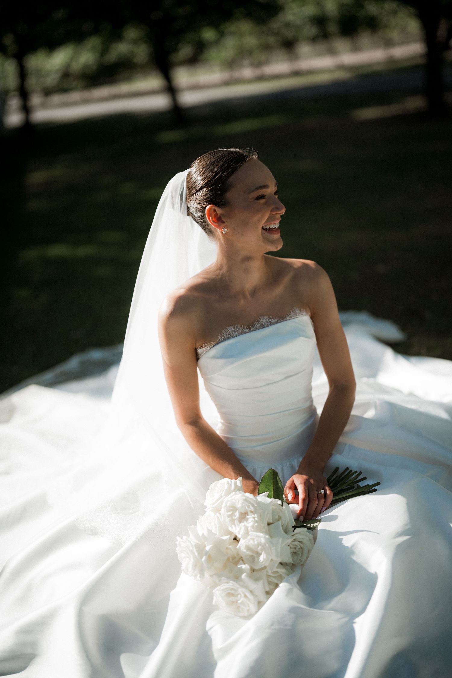Sunlit bridal portraits showing flowing white dress and natural joy.