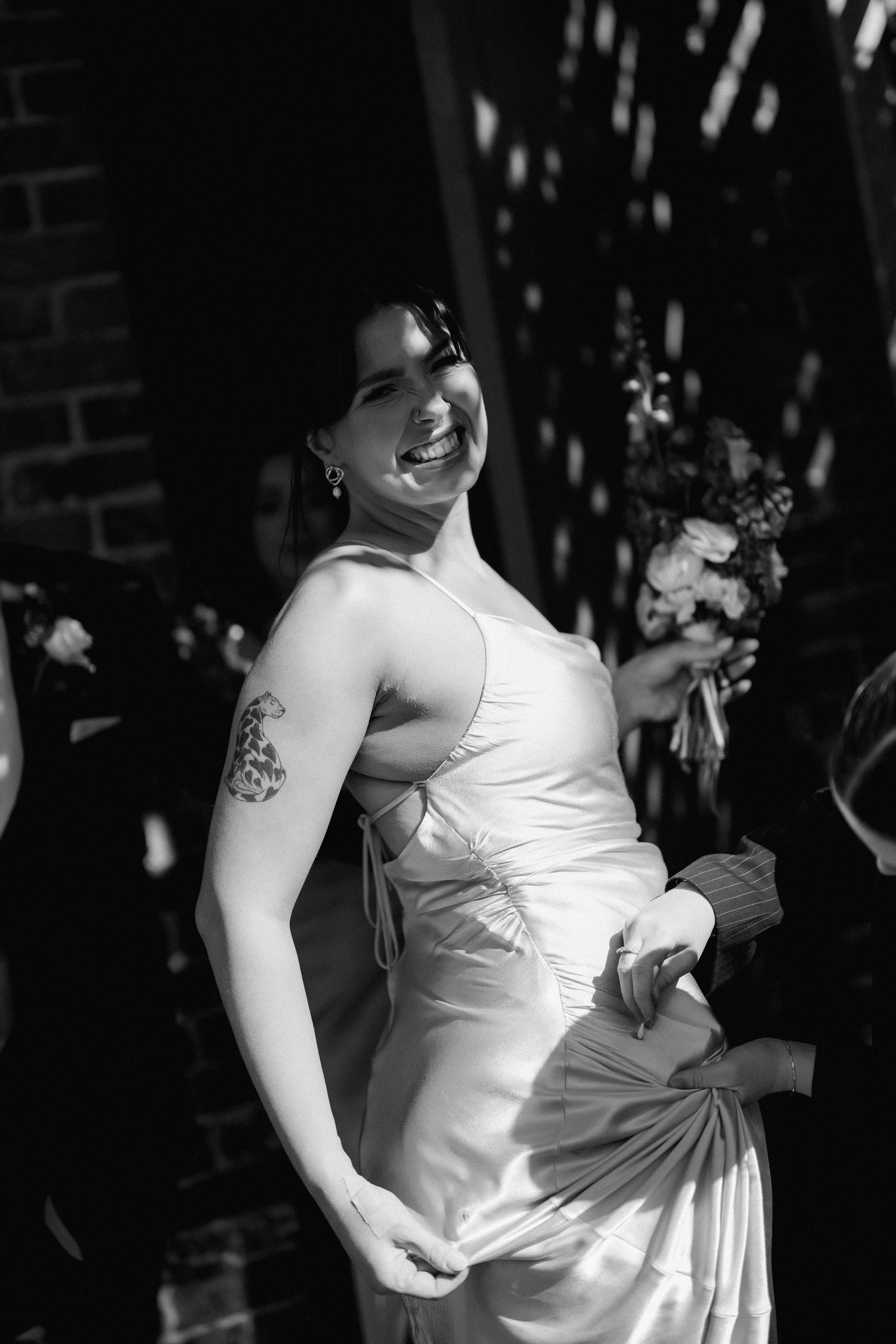 Black and white portraits showcase bride's elegant white dress details and natural expressions.