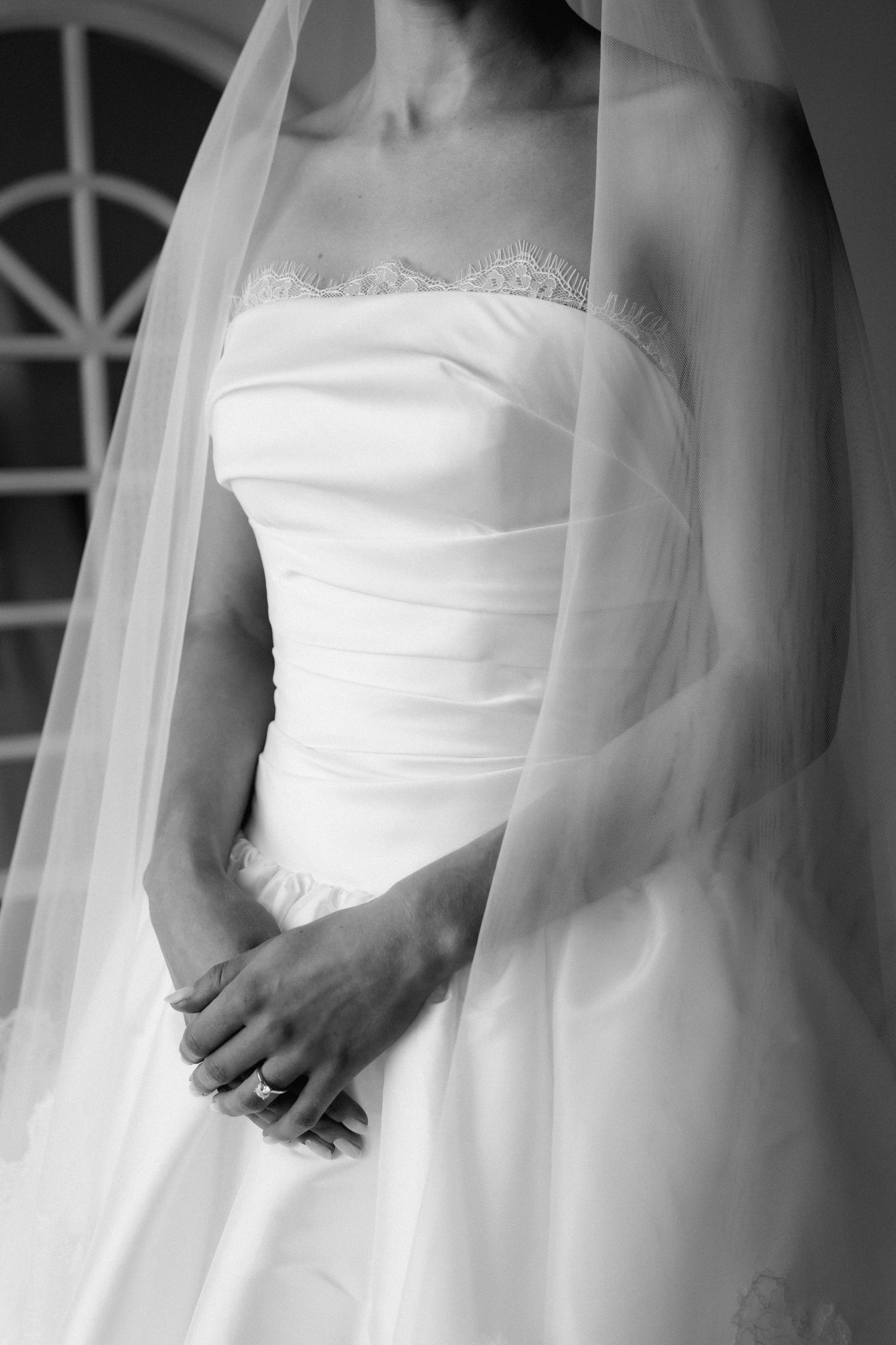 Elegant white wedding dress details showing flowing fabric and strapless bodice.