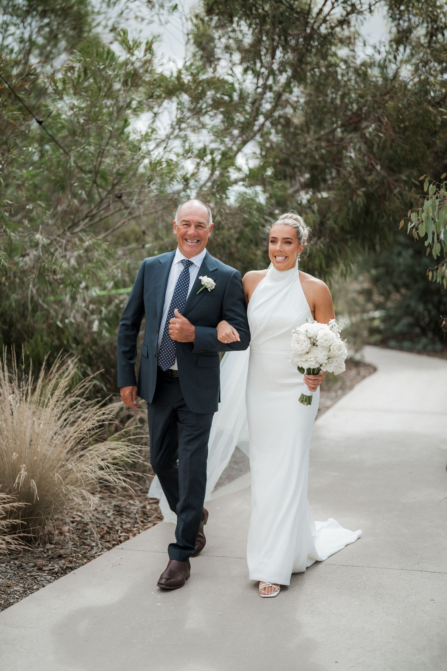 A series of wedding photos showing a couple walking down a concrete path surrounded by greenery.