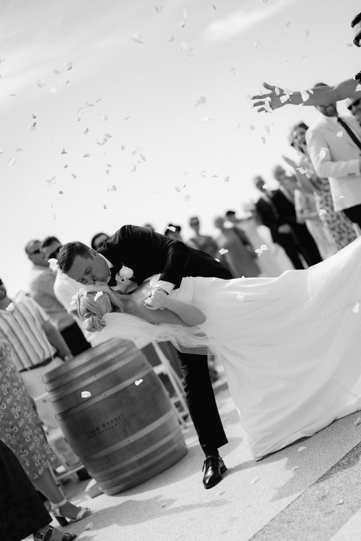 A dramatic black and white shot of newlyweds sharing their first dance at a wedding celebration.