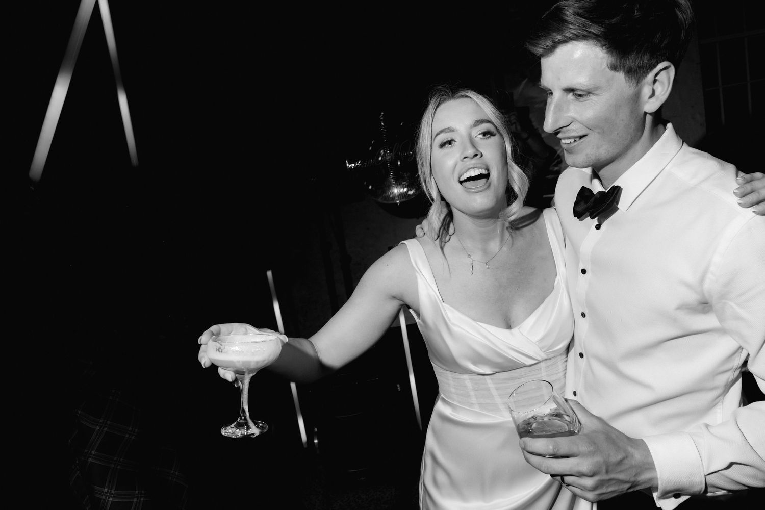 Black and white candid photos of wedding reception moments with natural expressions.