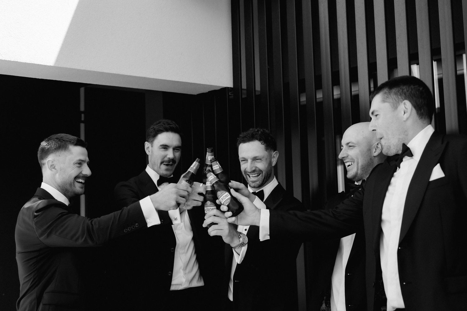 Black and white photo series showing groomsmen getting ready in formal attire.