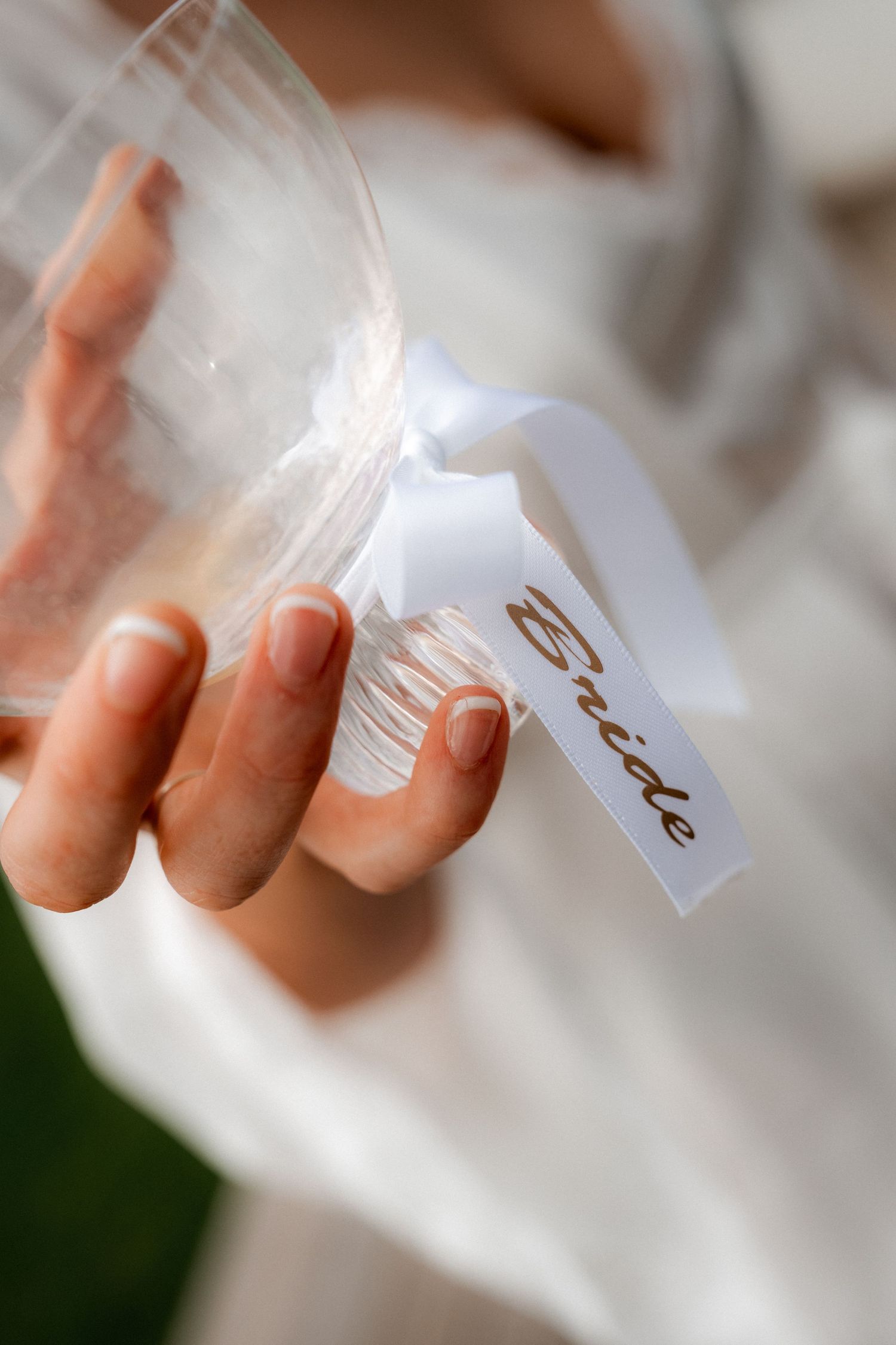 Close-up sequence of hands holding delicate white paper tags in soft natural light.